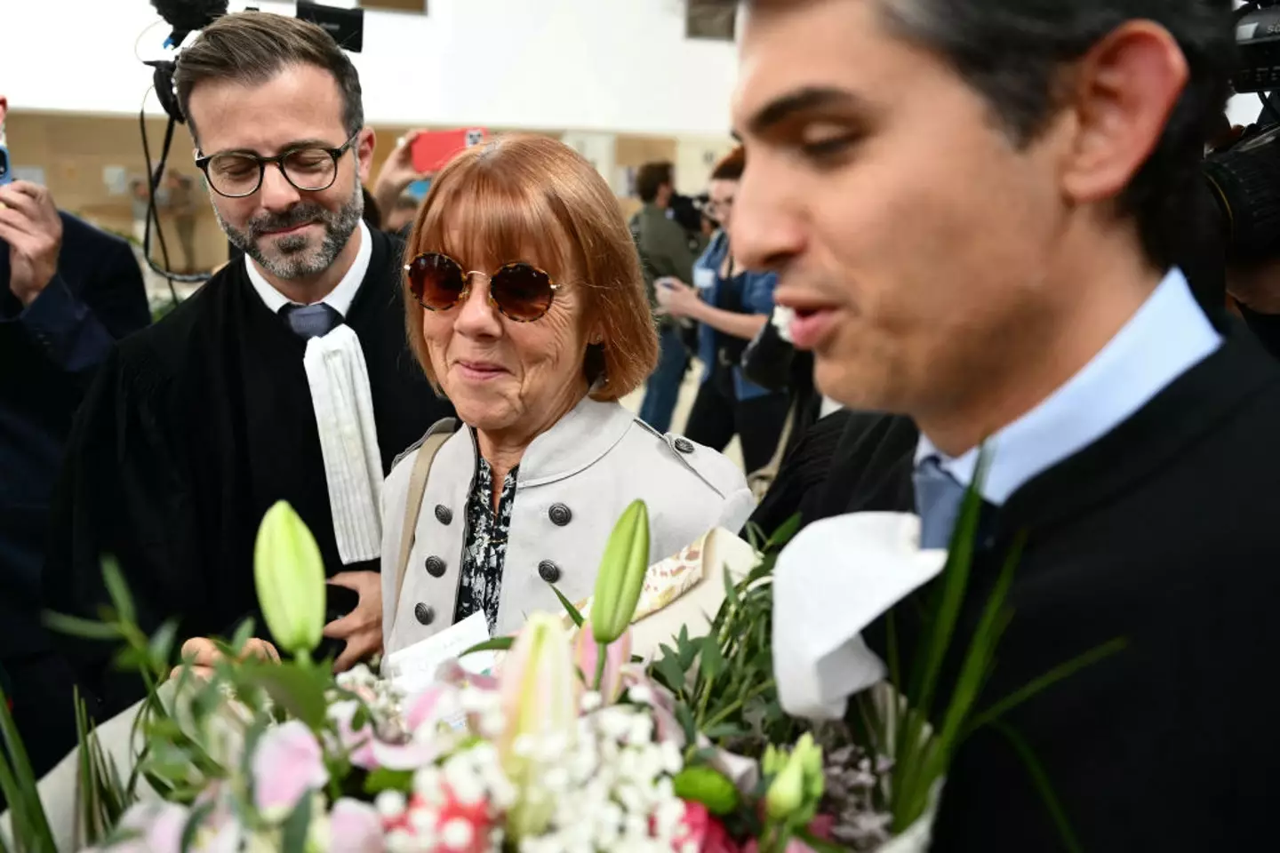 Gisèle Pelicot was greeted with flowers at the courthouse (CHRISTOPHE SIMON/AFP via Getty Images)