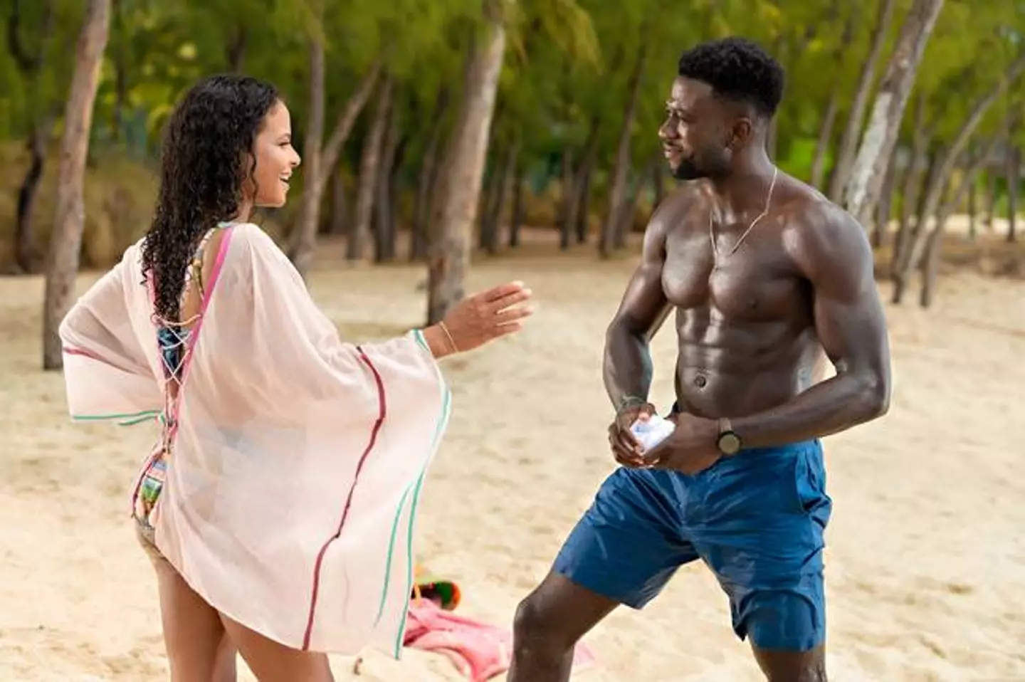 Erica (Christina Milian) and Caleb (Sinqua Walls) have a rendezvous at the beach (
