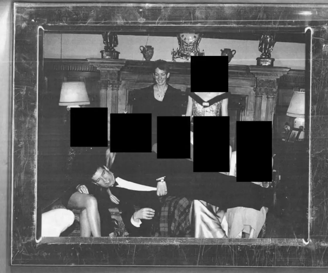 Andrew Mountbatten Windsor is pictured laying across the laps of a group of people (Department of Justice)