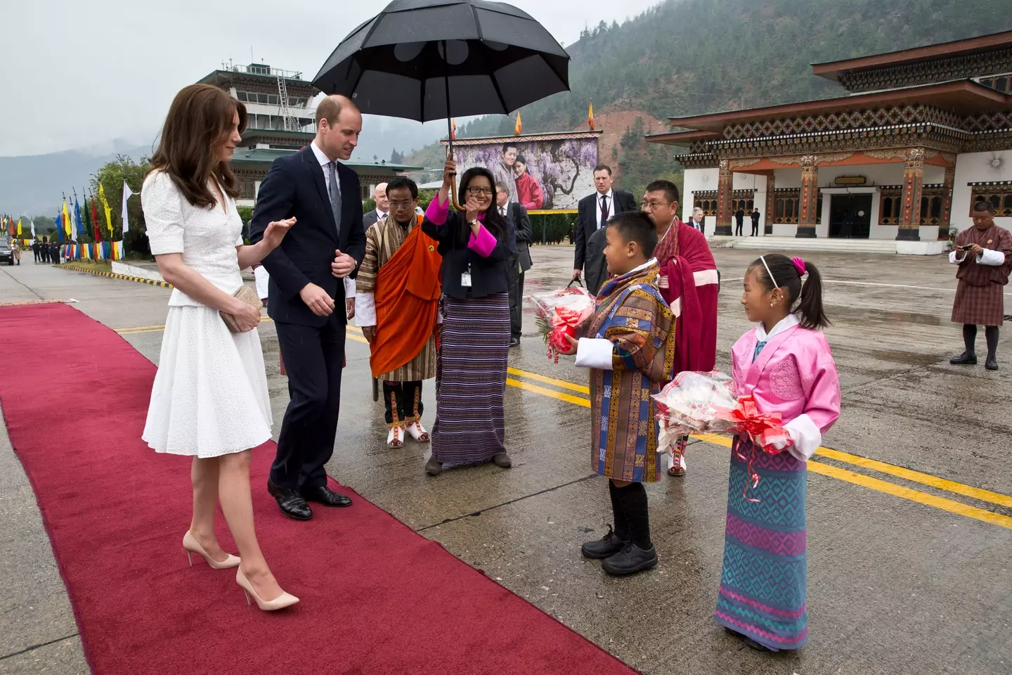 Kate and William presented with flowers as they bid farewell at Paro Airport before boarding their flight to Agra for their visit to the Taj Mahal on April 16, 2016 in Paro, Bhutan (Photo by Heathcliff O'Malley-Pool/Getty Images)