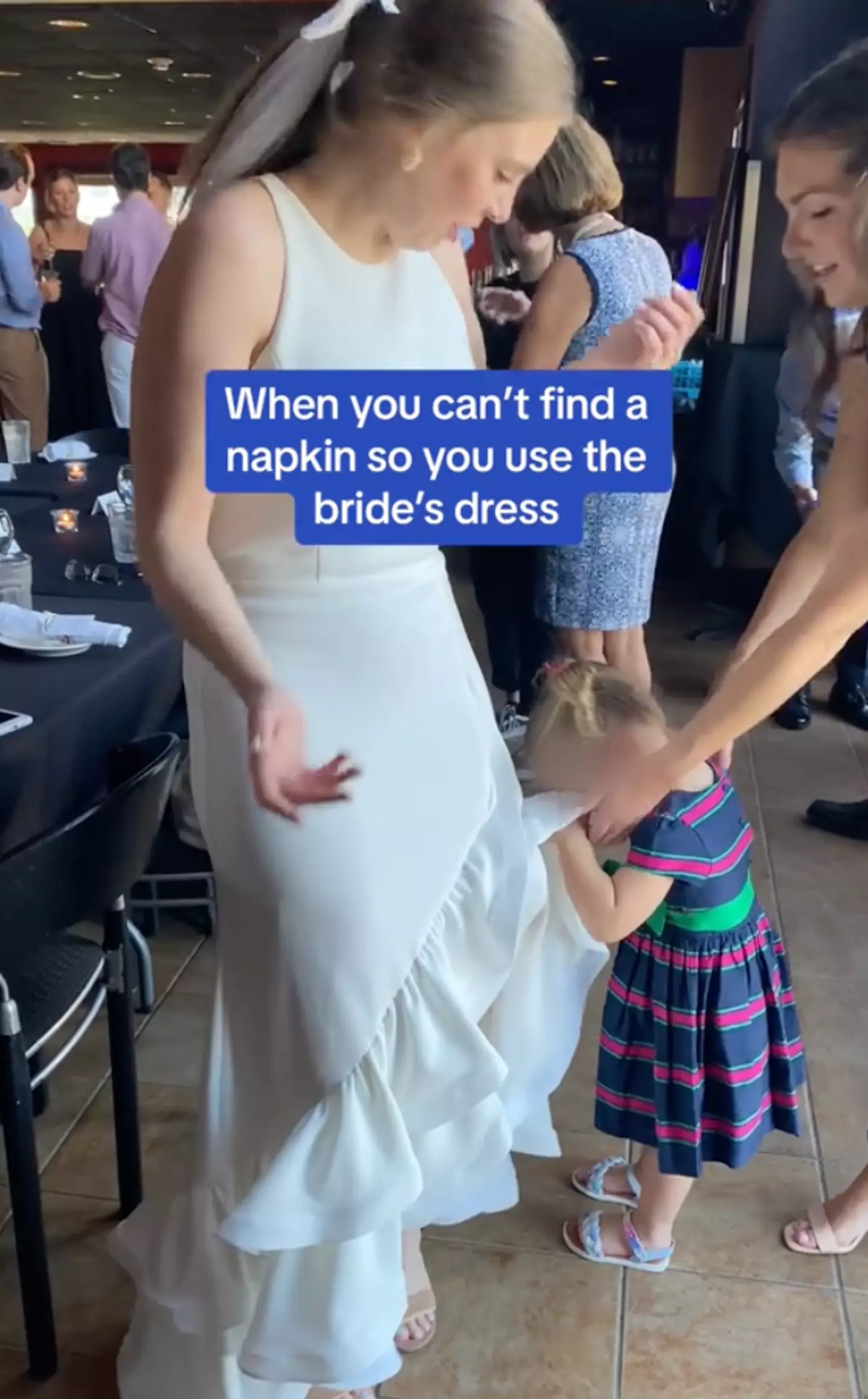 A child decided to use a wedding dress as a napkin.