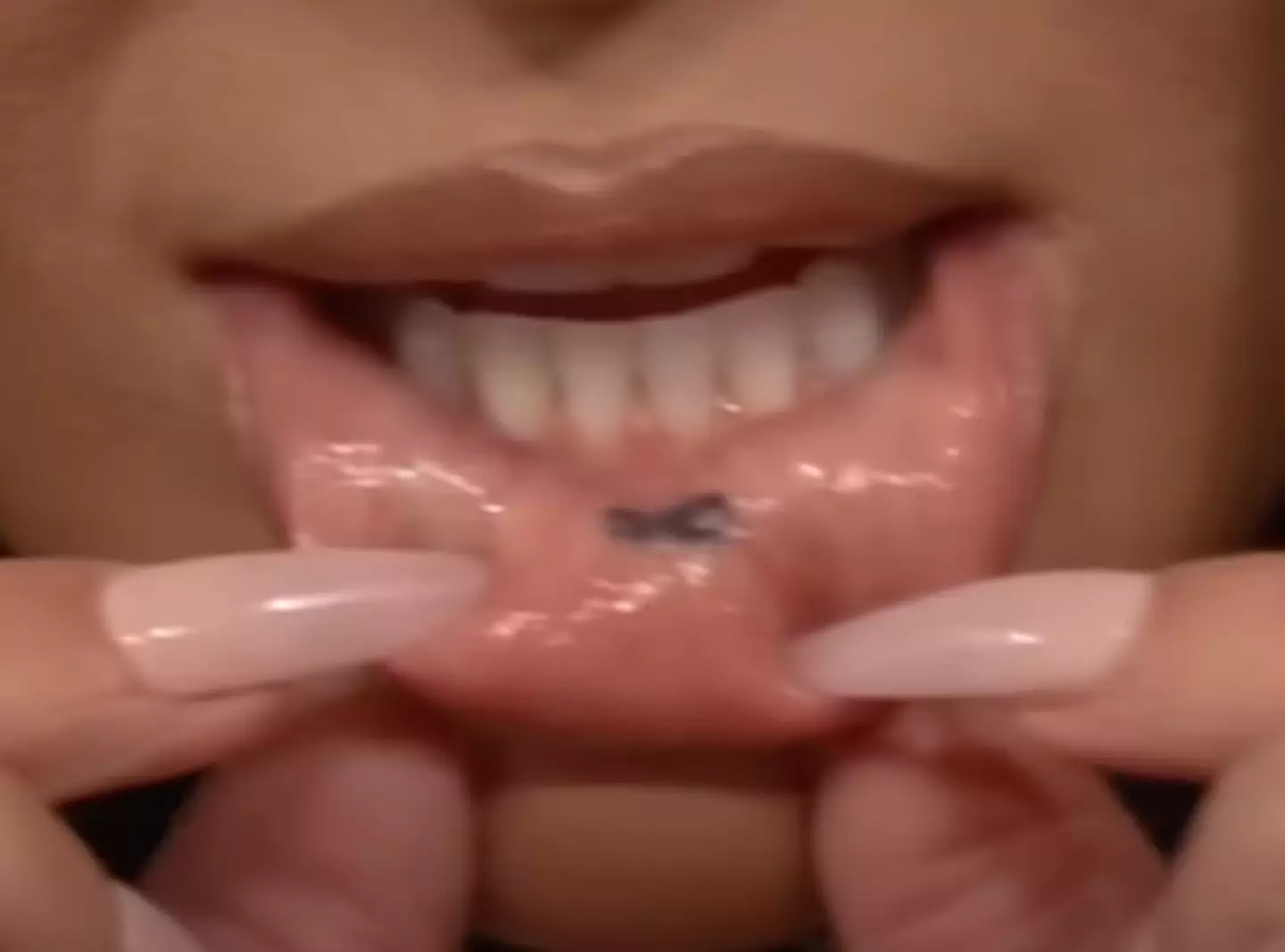 Kim's tatt is an infinity symbol inked in black on the inside of her bottom lip (Tonight Show)