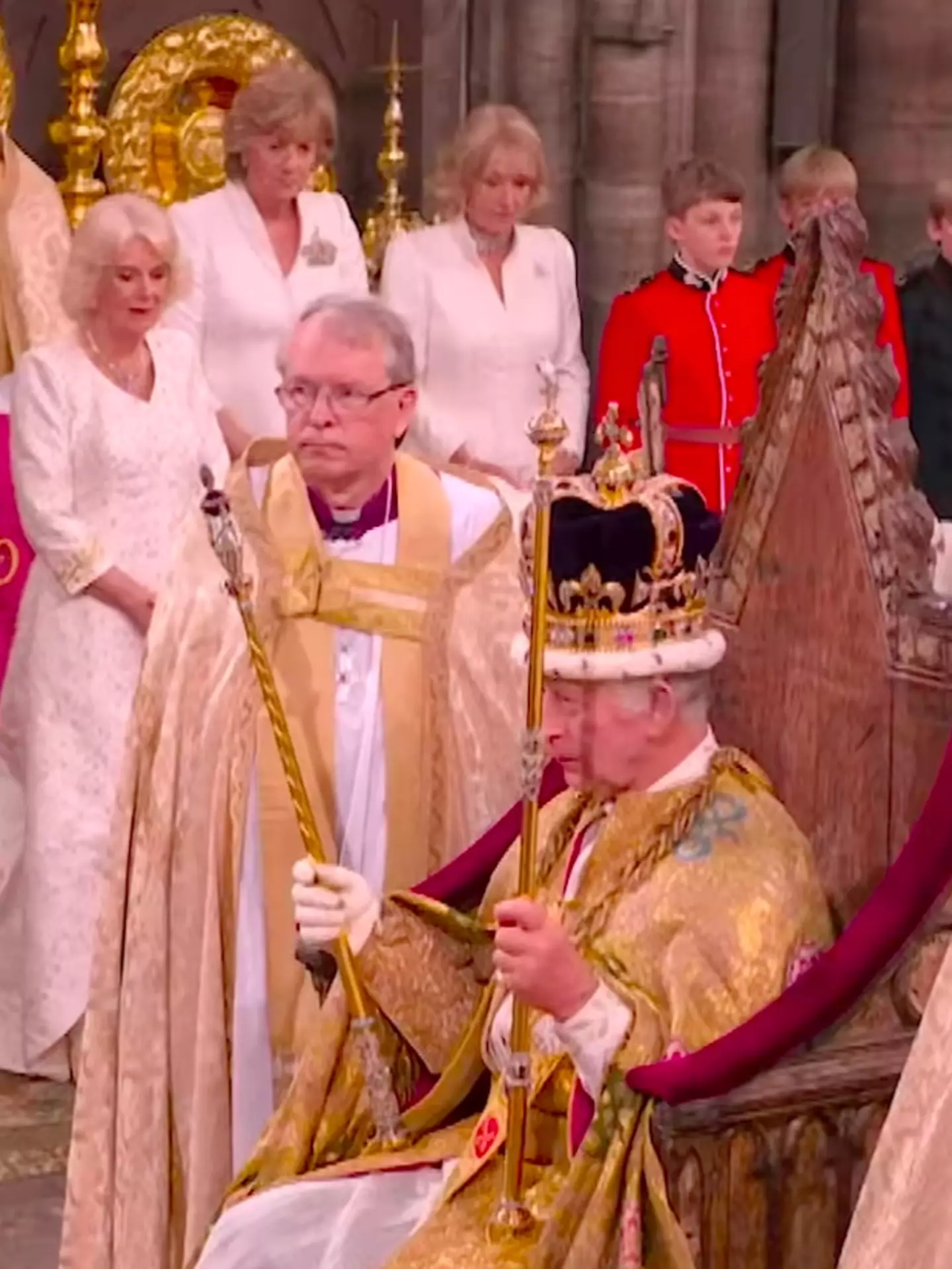 Prince Harry and William watched their father receive the crown.