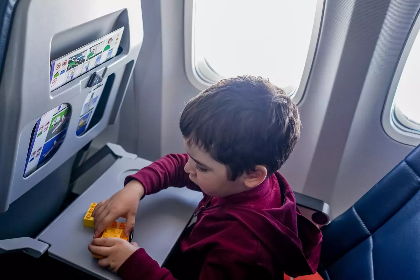 A mum's partners wants her to leave her son in economy while they fly business class.