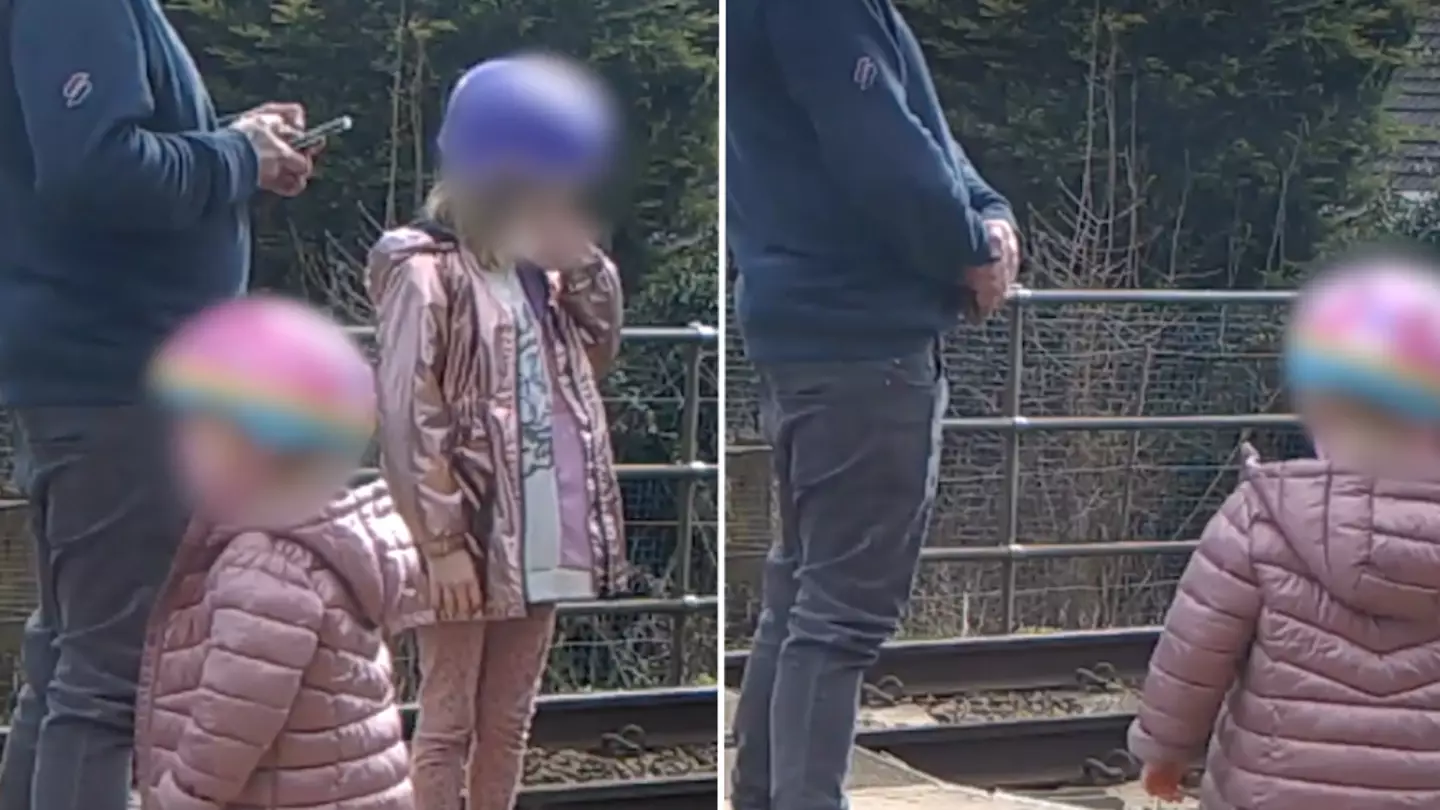 Toddler dances on tracks as oblivious father plays on phone while train is coming