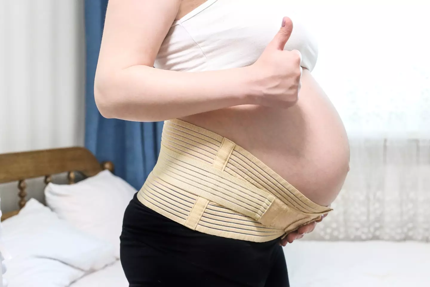 A belly support band or belt may help with the pain (Natalya Trofimchuk / Getty Images)