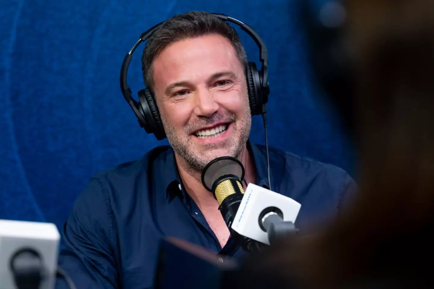 He does smile sometimes! (Emma McIntyre/Getty Images for SiriusXM)