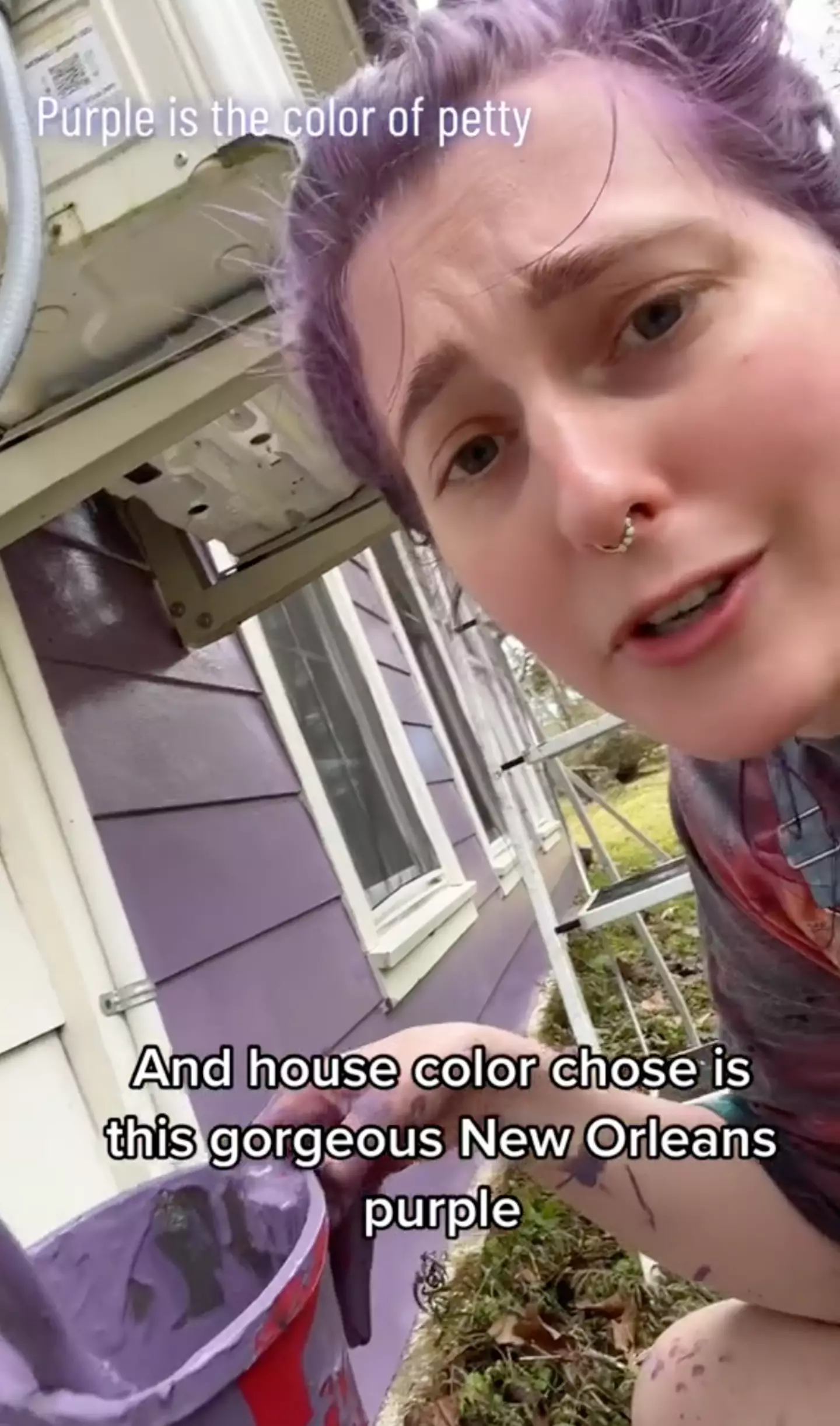 So, she's painting MORE purple onto the house.