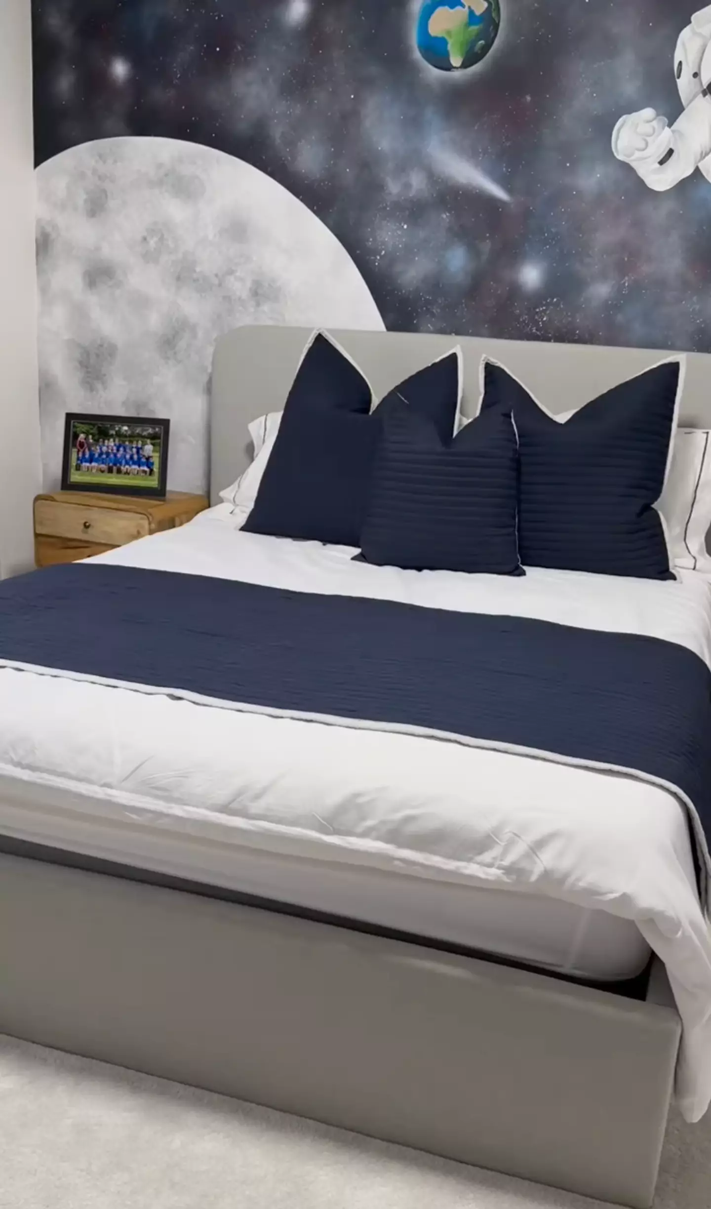 Chester's room is navy blue and space-themed.
