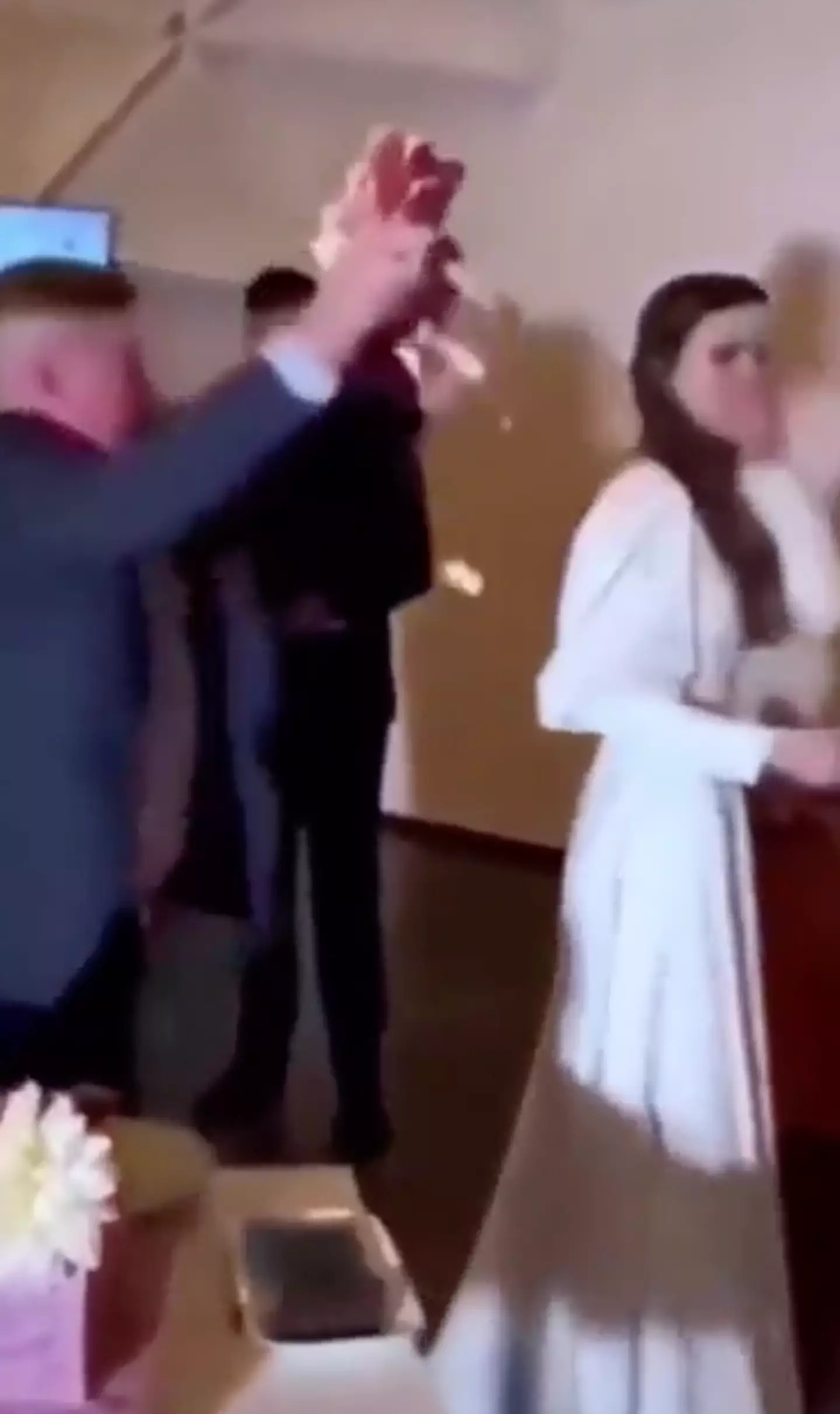 A video has been making its rounds on social media showing a man throw cake at a bride and groom.
