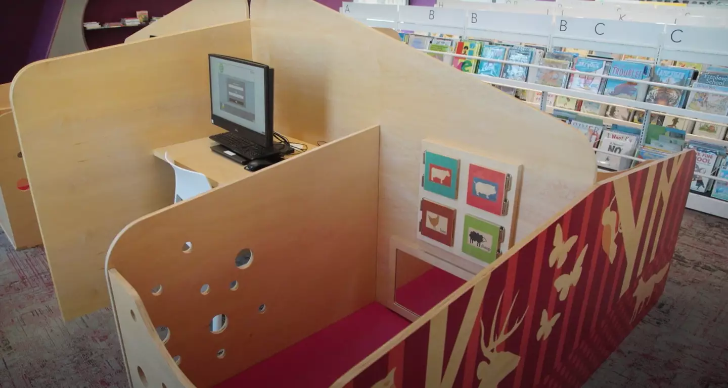One library has received an avalanche of praise from by families for having baby cribs attached to its desks.