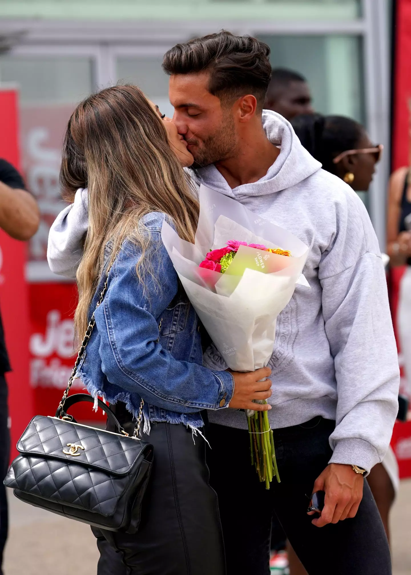 The pair looked loved up as they touched down in the UK.