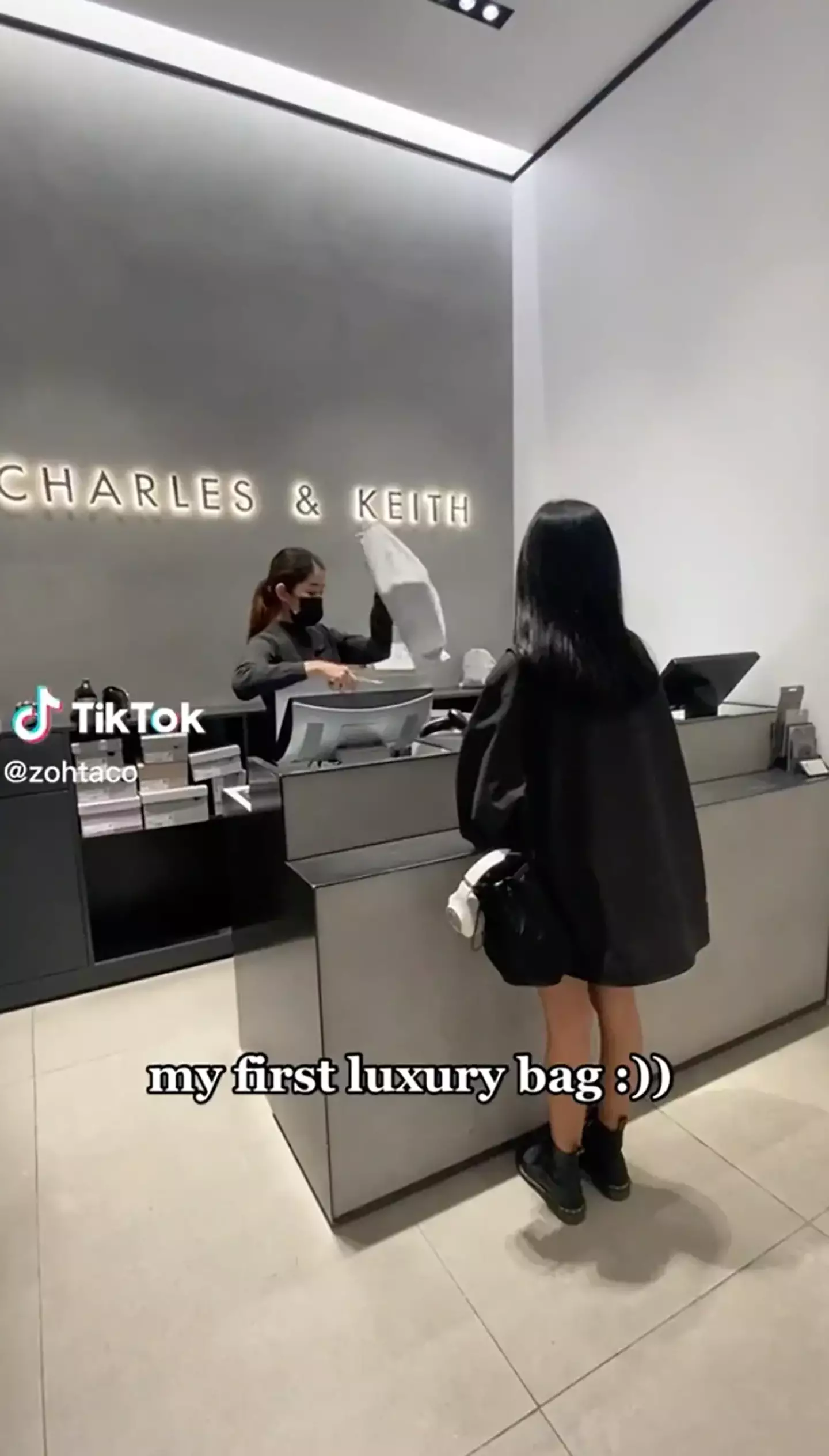 Zoe picking up her new handbag from the Charles & Keith counter.