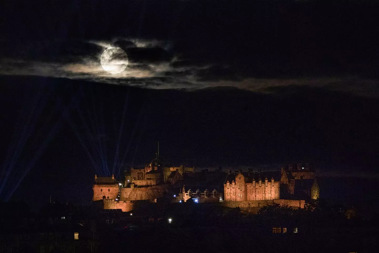 The Sturgeon Moon through the clouds at Edinburgh Castle.