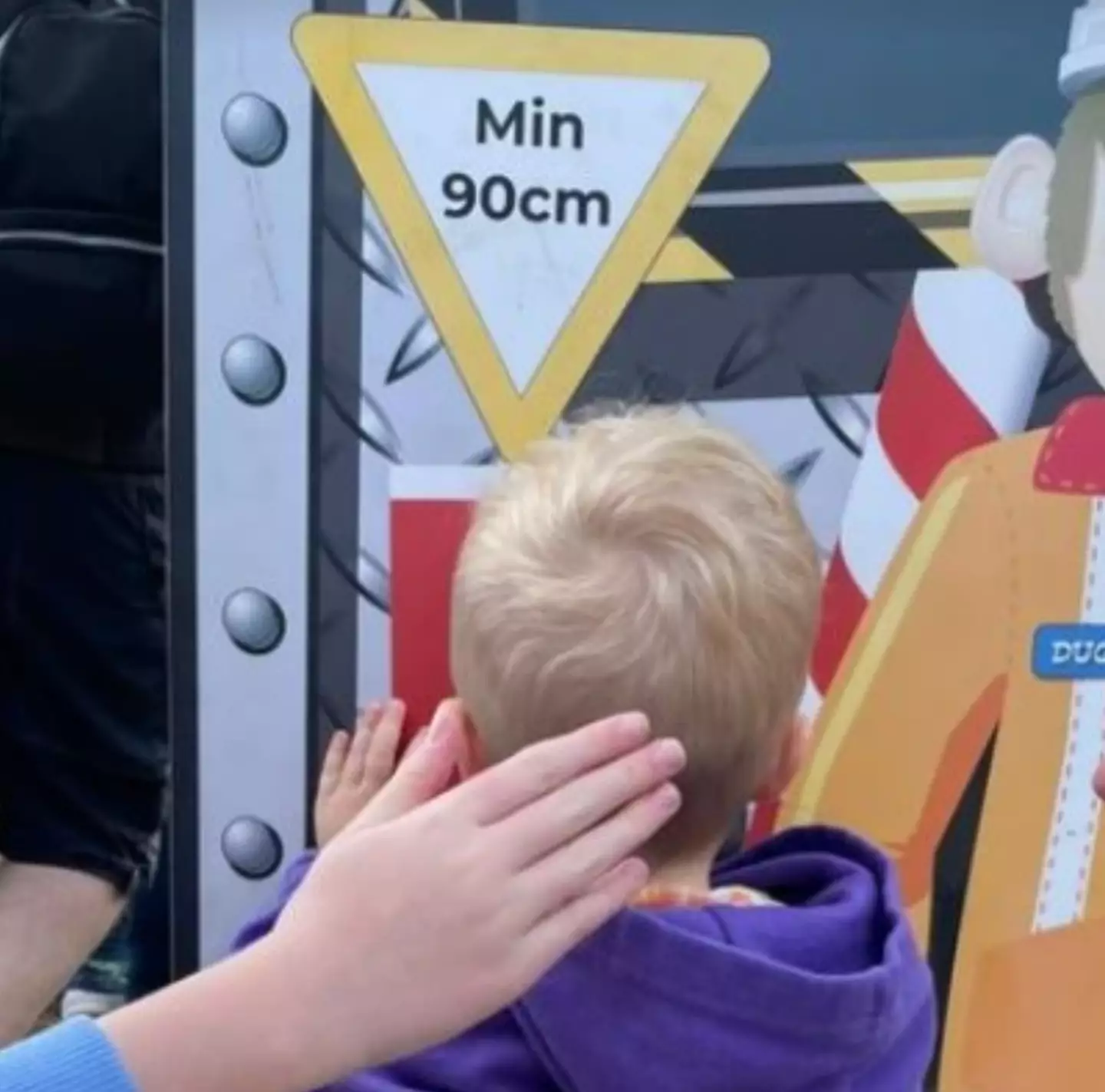 Katherine proved Fred was tall enough for the ride.