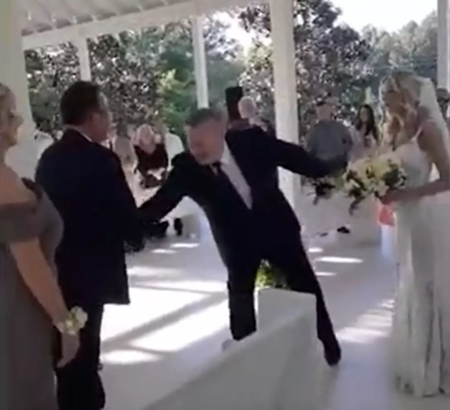 The father of the bride brought her stepfather over to help walk his daughter down the aisle.