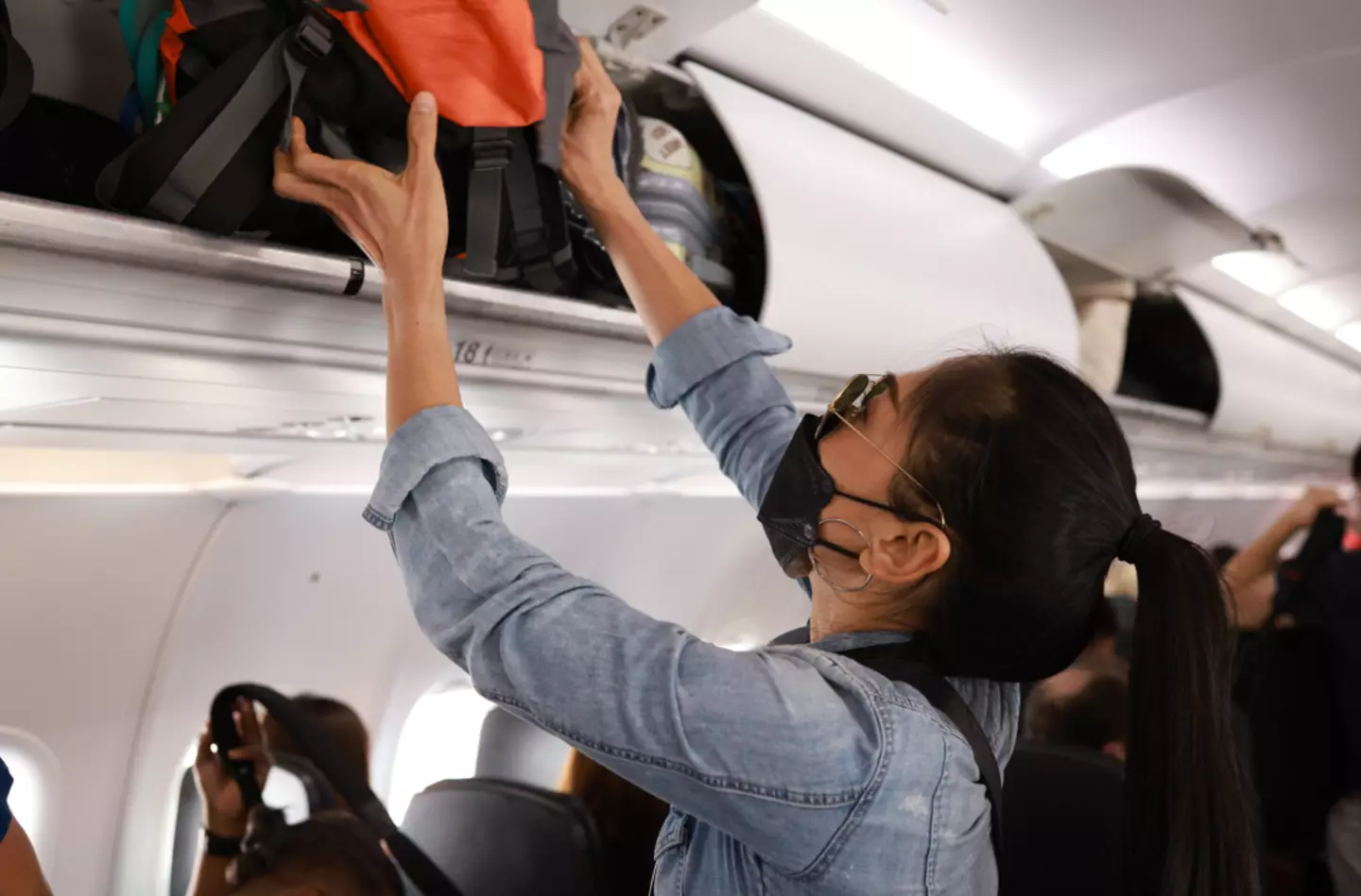 Passengers rushing to grab their overhead luggage will face similar fines (Getty Stock Image)