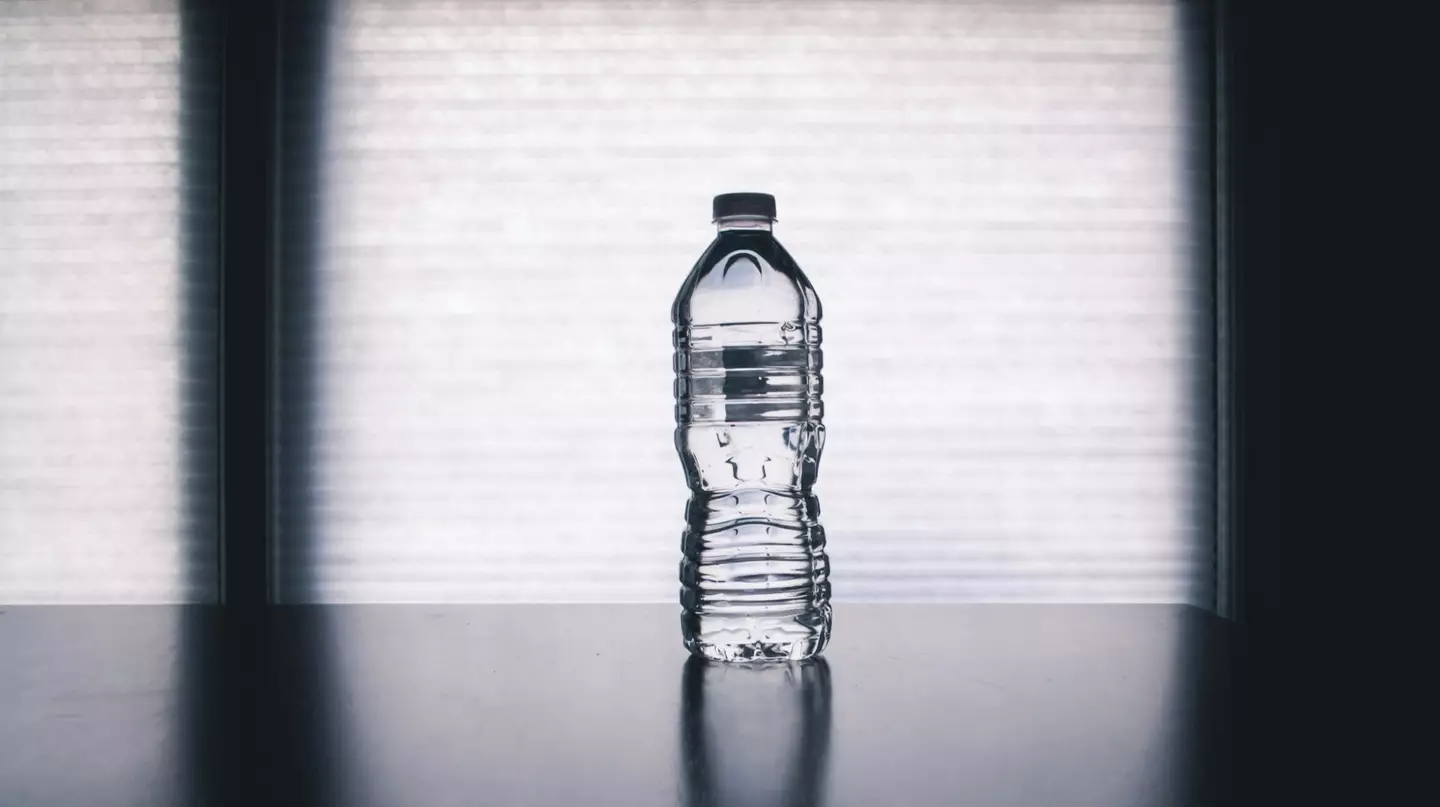 A water bottle rolled under the bed can show if someone is hiding underneath or not. (Pexels)