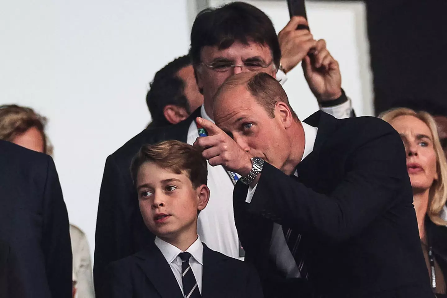Many royal fans questioned why George wasn't wearing a football shirt, and instead donned a matching suit with his father (ADRIAN DENNIS/AFP via Getty Images)