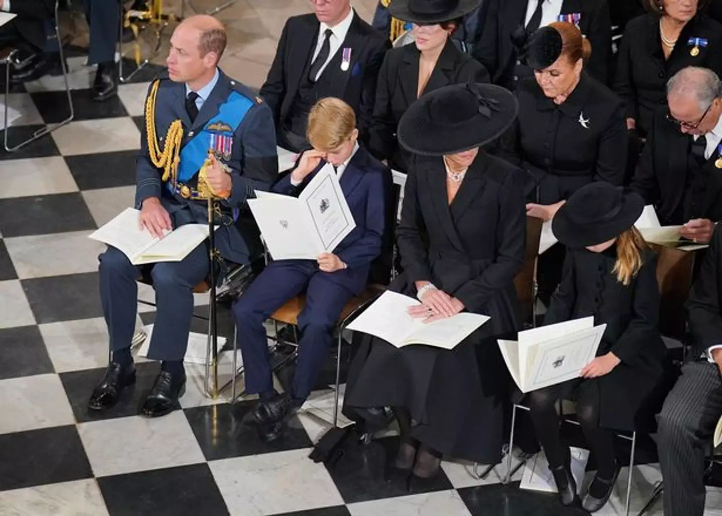Prince George wipes away a tear.