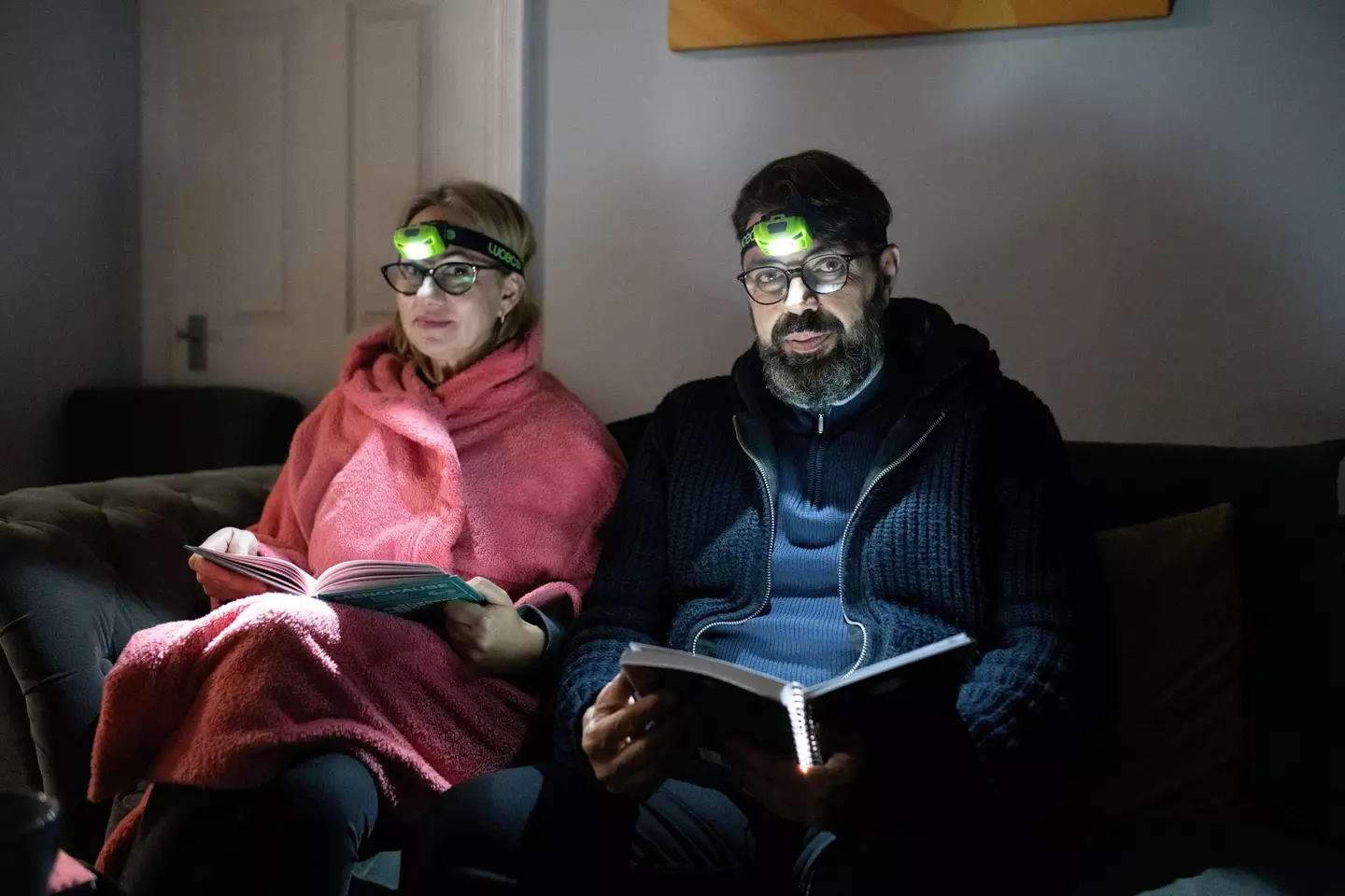 The family use headlamps to see in the dark.