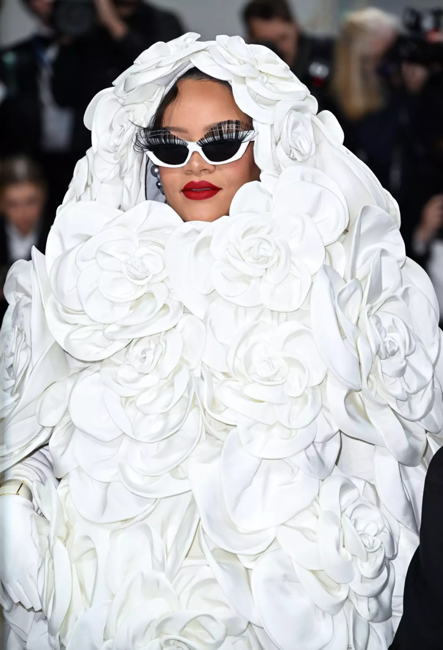 Rihanna accessorised the bold outfit with white sunglasses featuring 3D lashes.