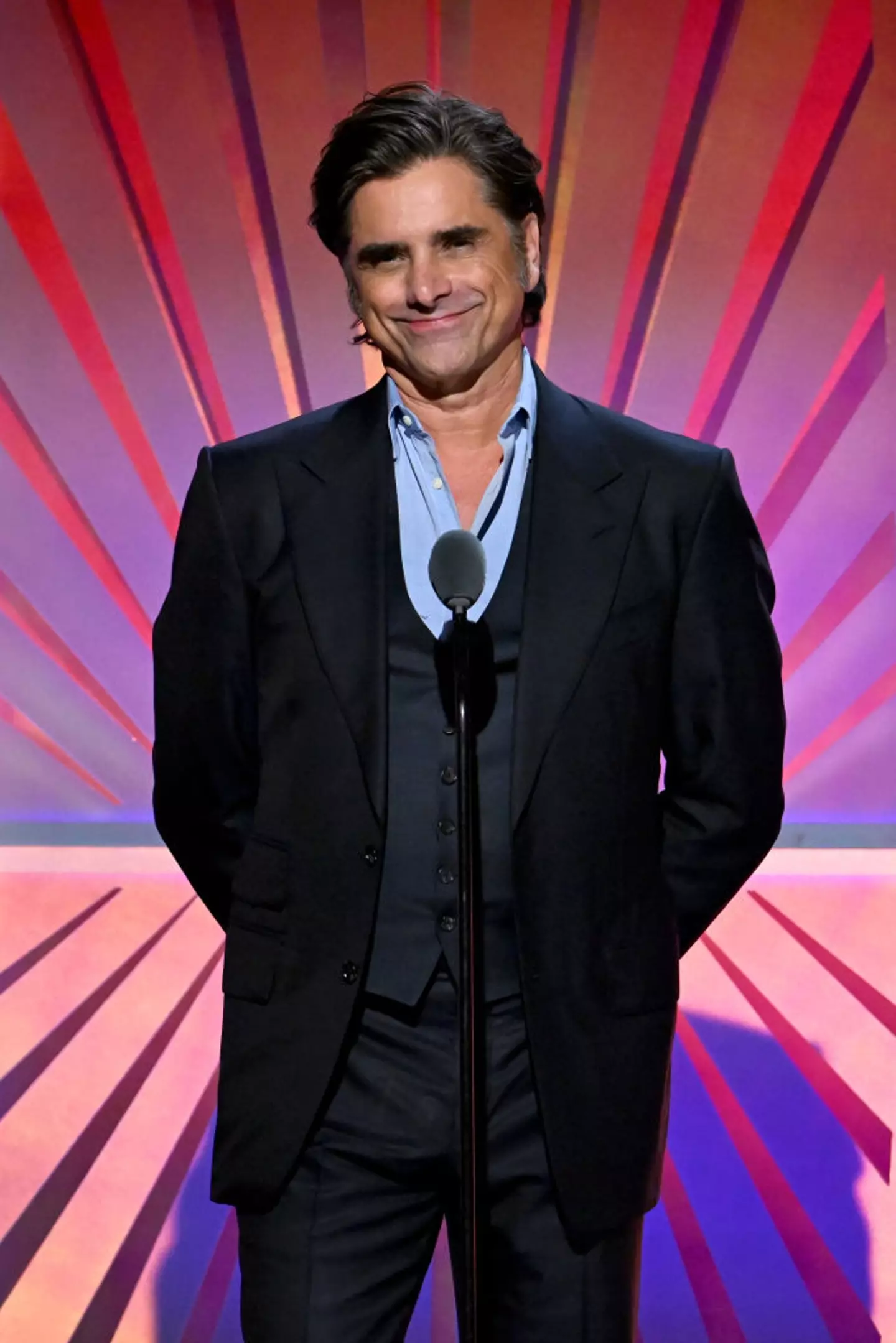 John Stamos shared an explanation about his attendance at the event (Michael Kovac/Getty Images for AARP)
