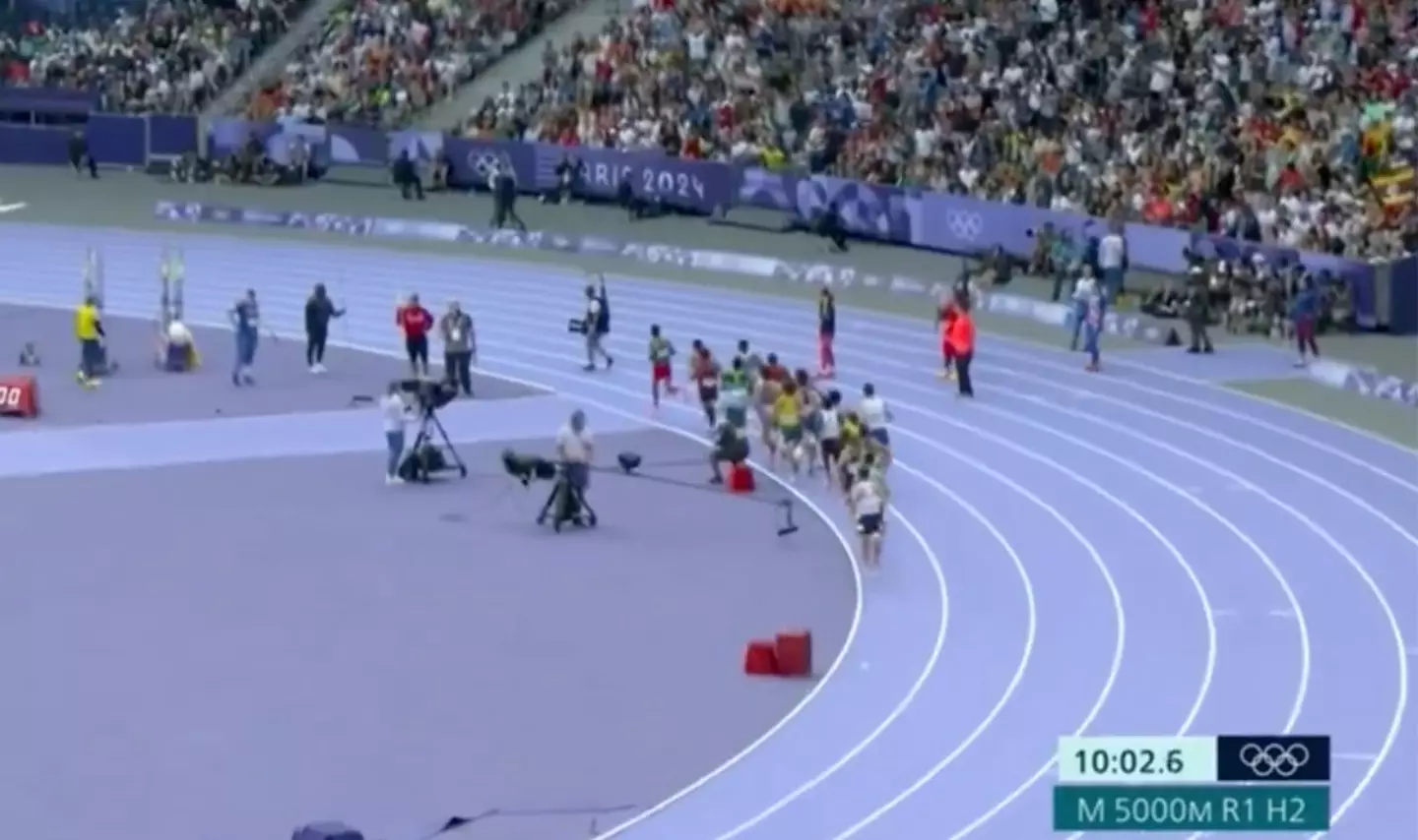 A cameraman wandered into the men's 1500m heat. (BBC)