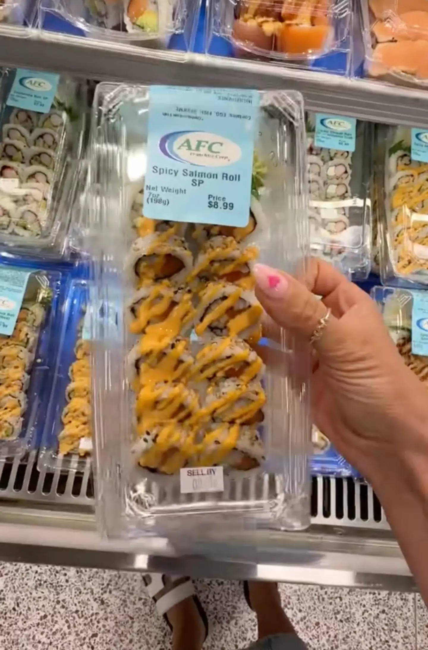 She picked up some sushi while shopping for the weekly groceries.