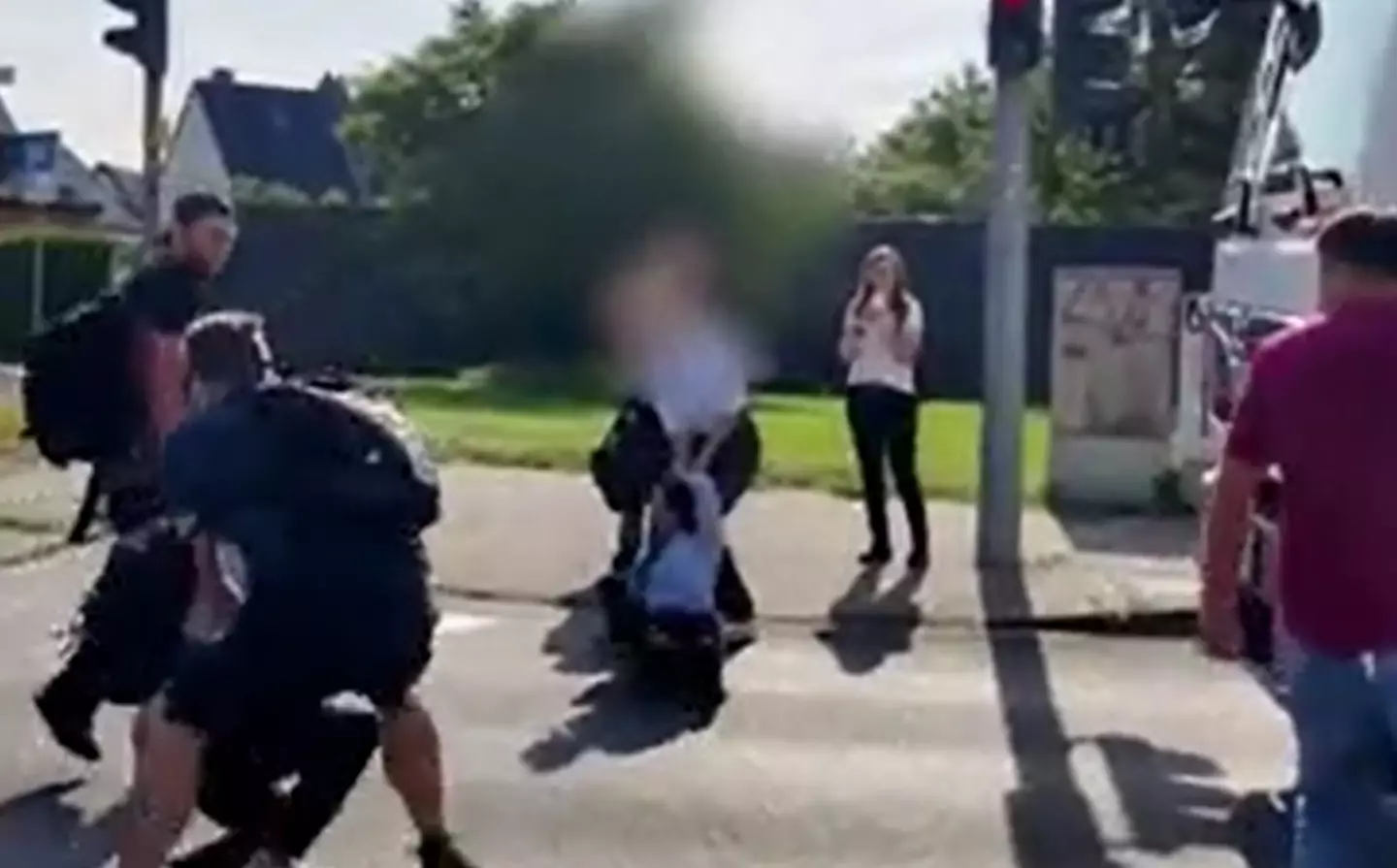 When the protestor got back onto the road the woman dragged her by the hair again.