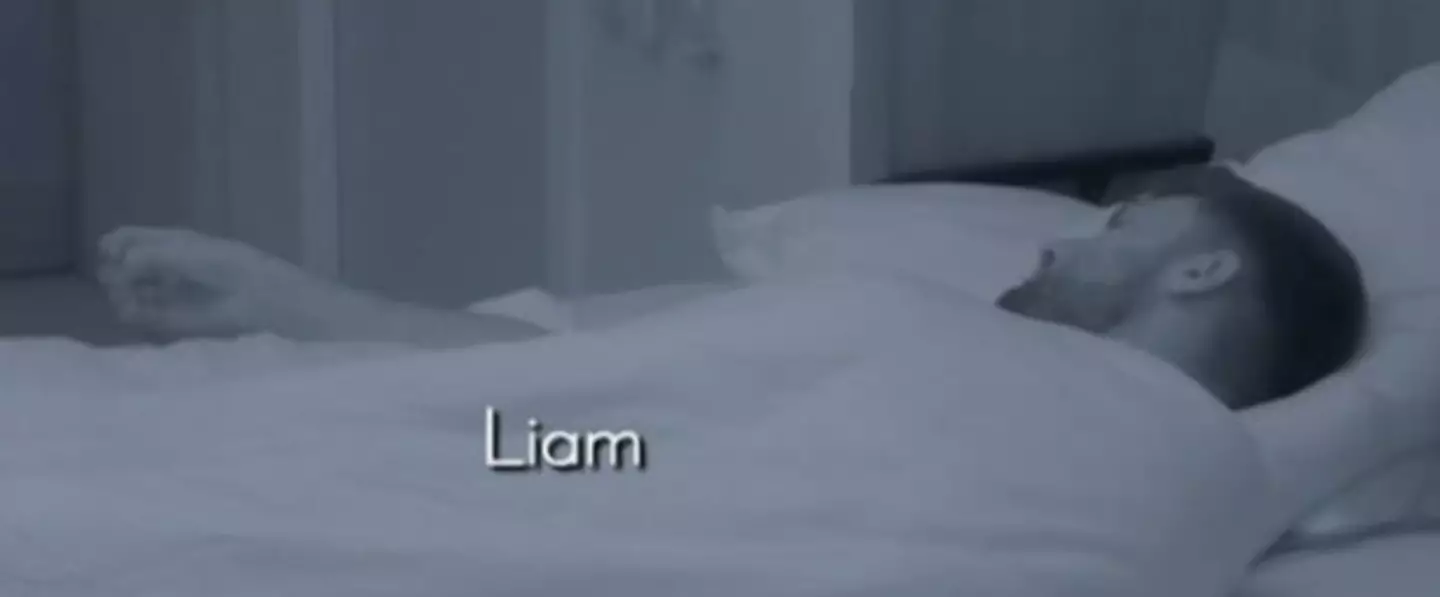 Liam stretched his arm out while in bed (