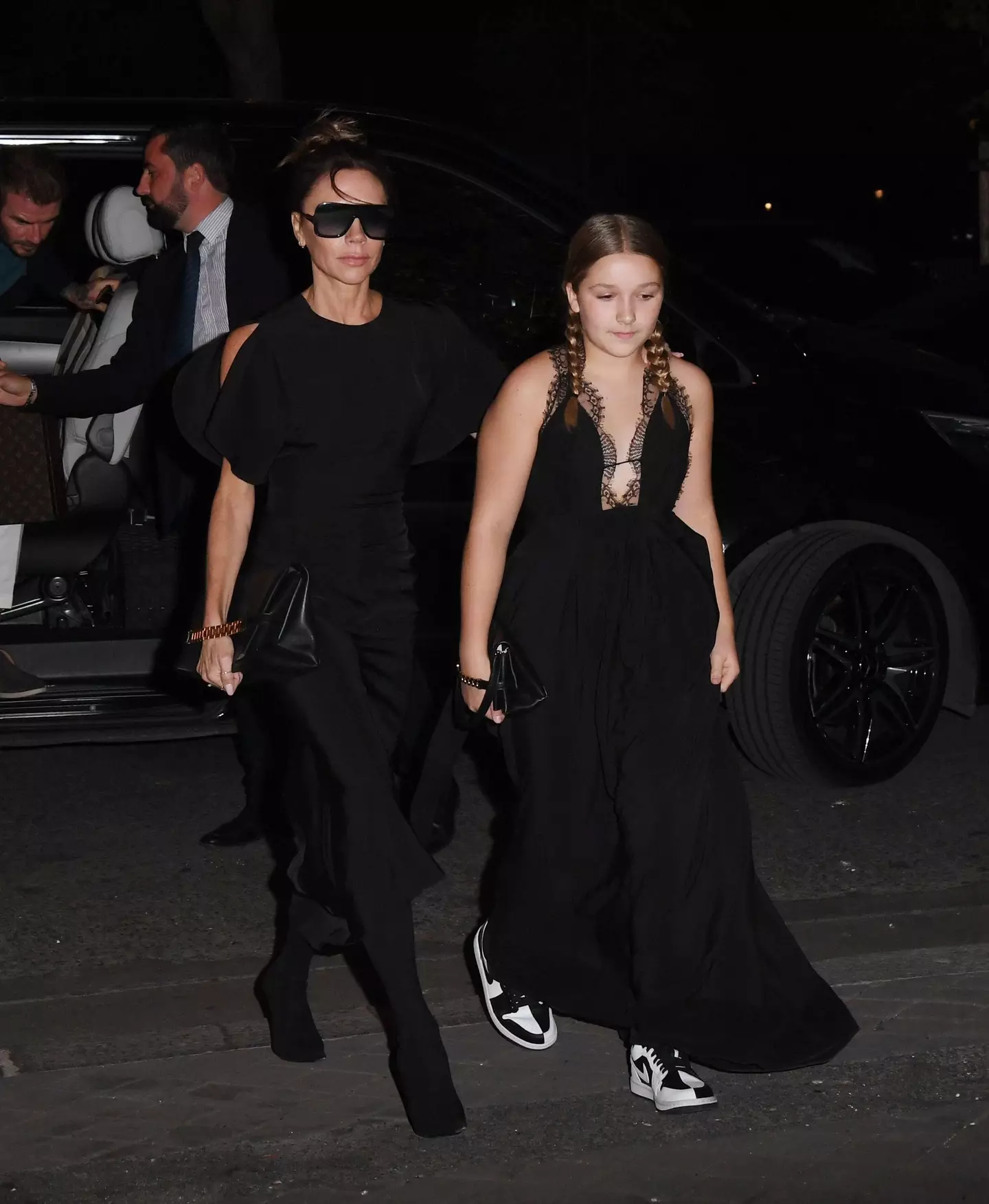 Harper Beckham wore a long black gown with Nike trainers for her mum, Victoria's fashion show.
