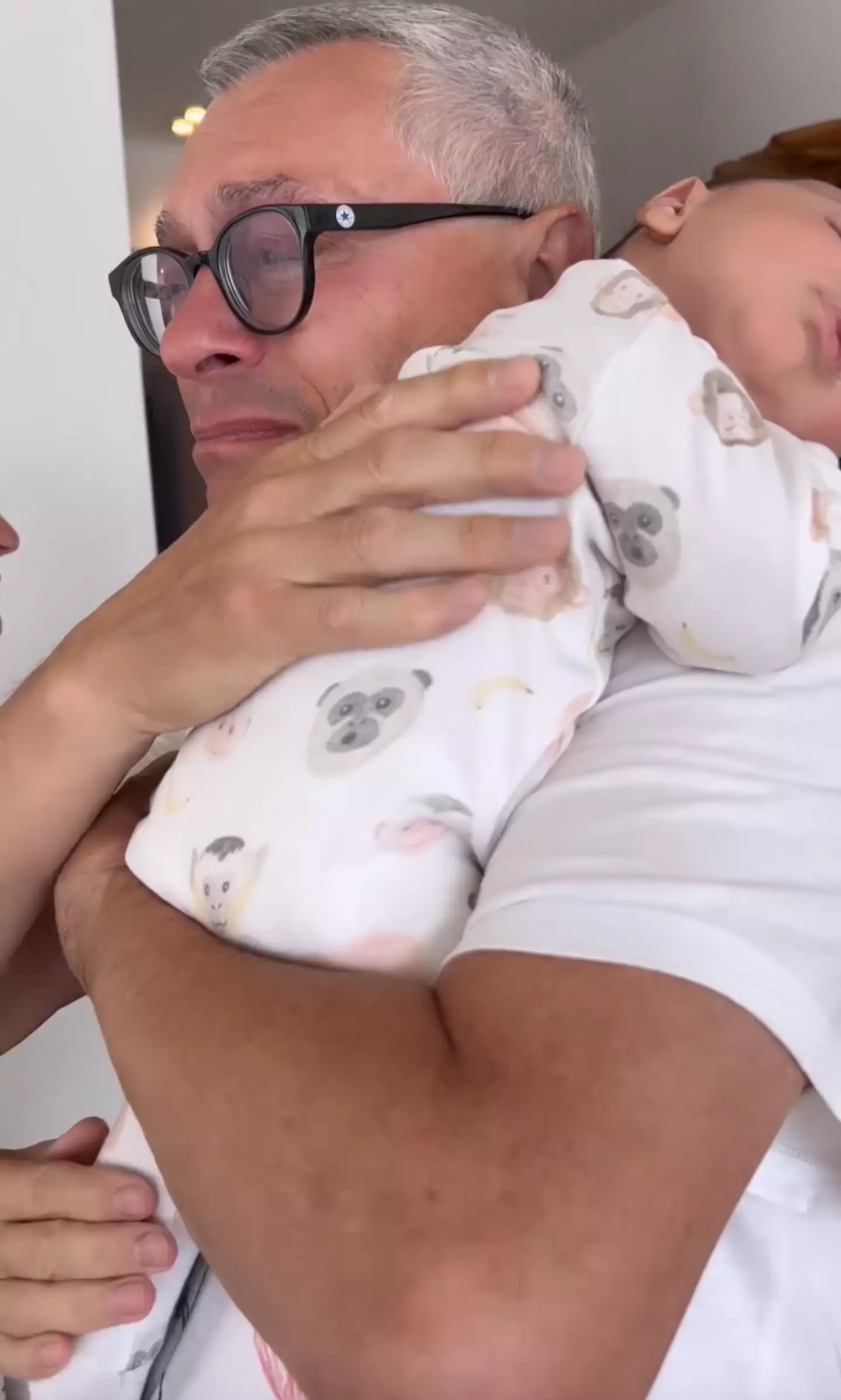 Jessie J’s dad appeared to be overcome with emotion while cuddling his new grandson.