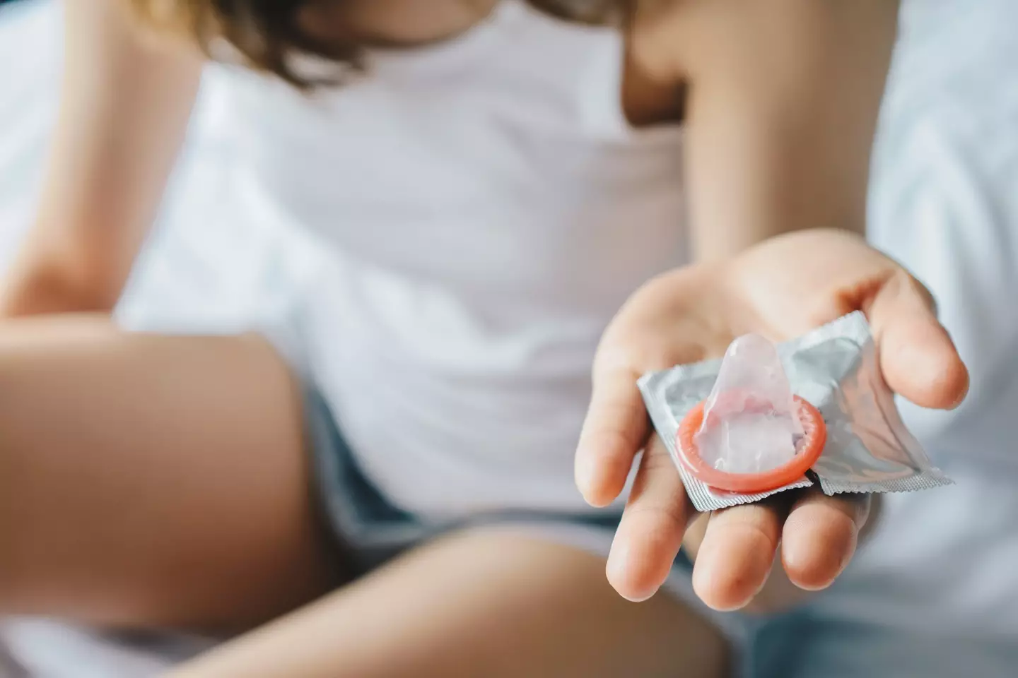 Be sure to open the condom packet carefully to avoid any breakages. (Boy_Anupong / Getty Images)