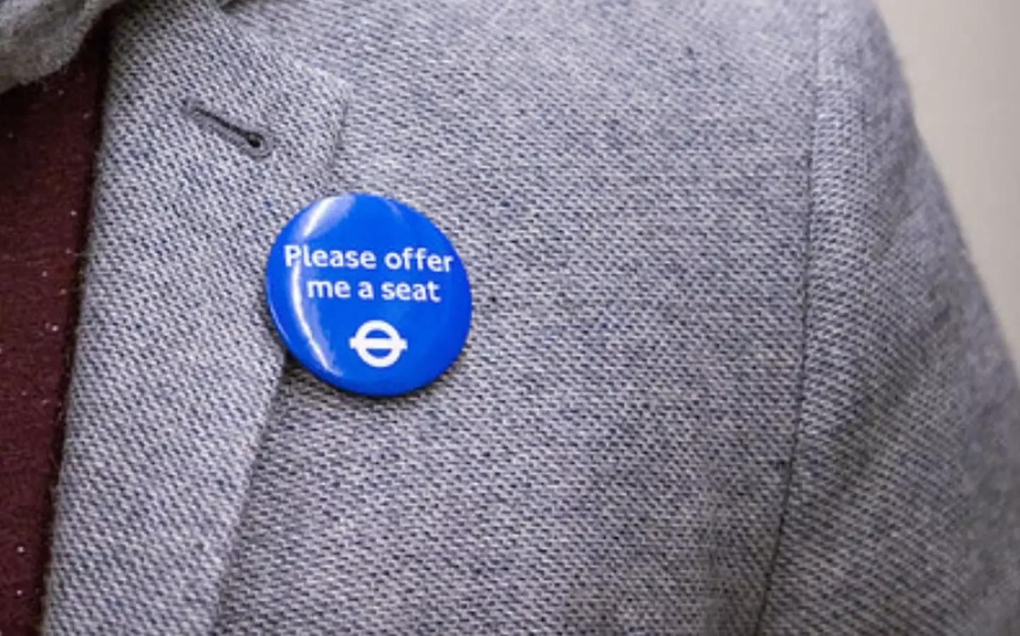 Some public transport operators offer badges for people who need seats even if it isn't immediately obvious.