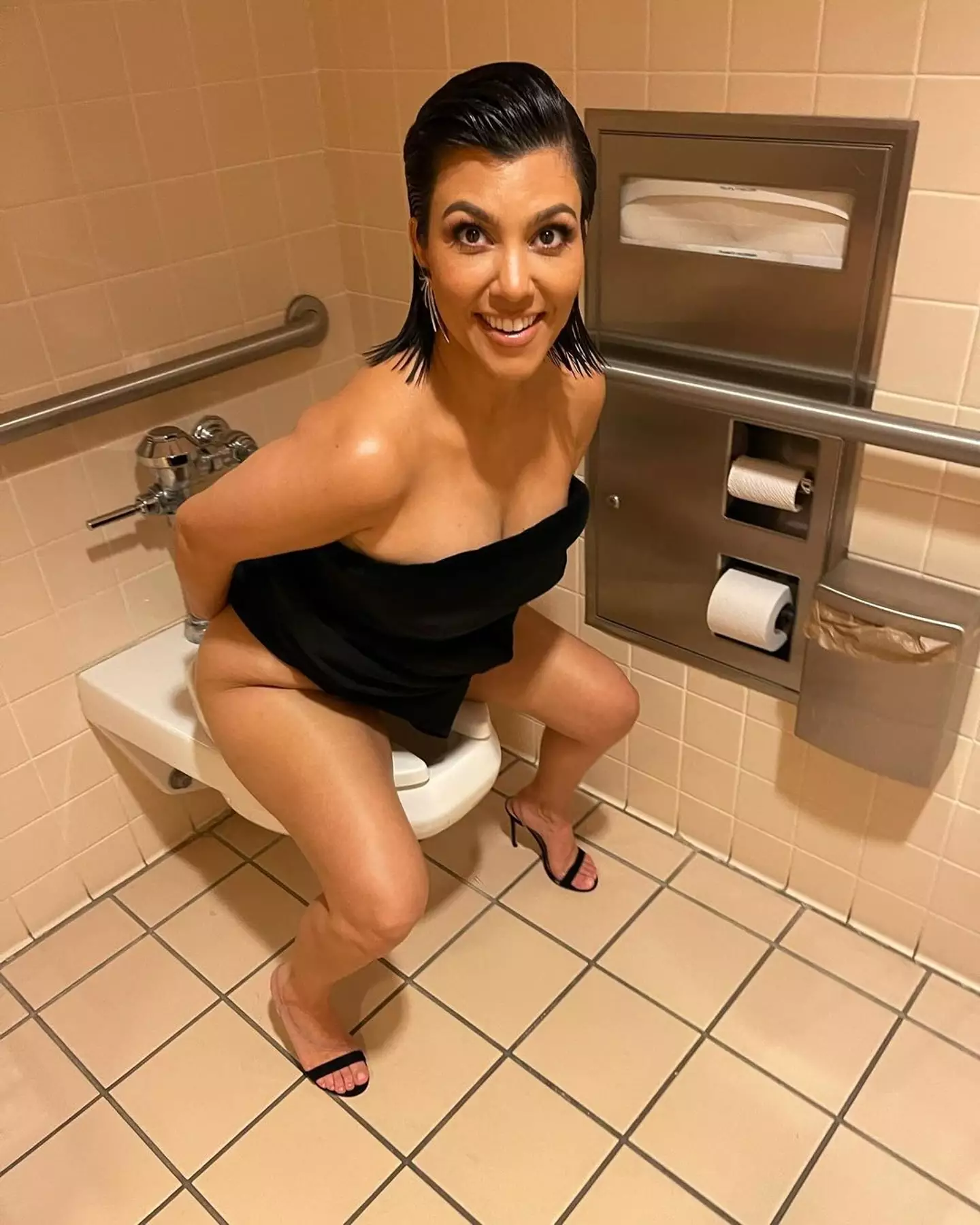 The final post on Travis' photo dump showed Kourtney on the toilet. (Instagram/@travisbarker)