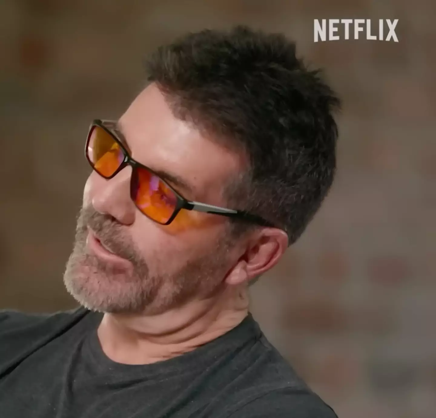 Fans have been questioning why Simon Cowell always wears orange glasses (Netflix)