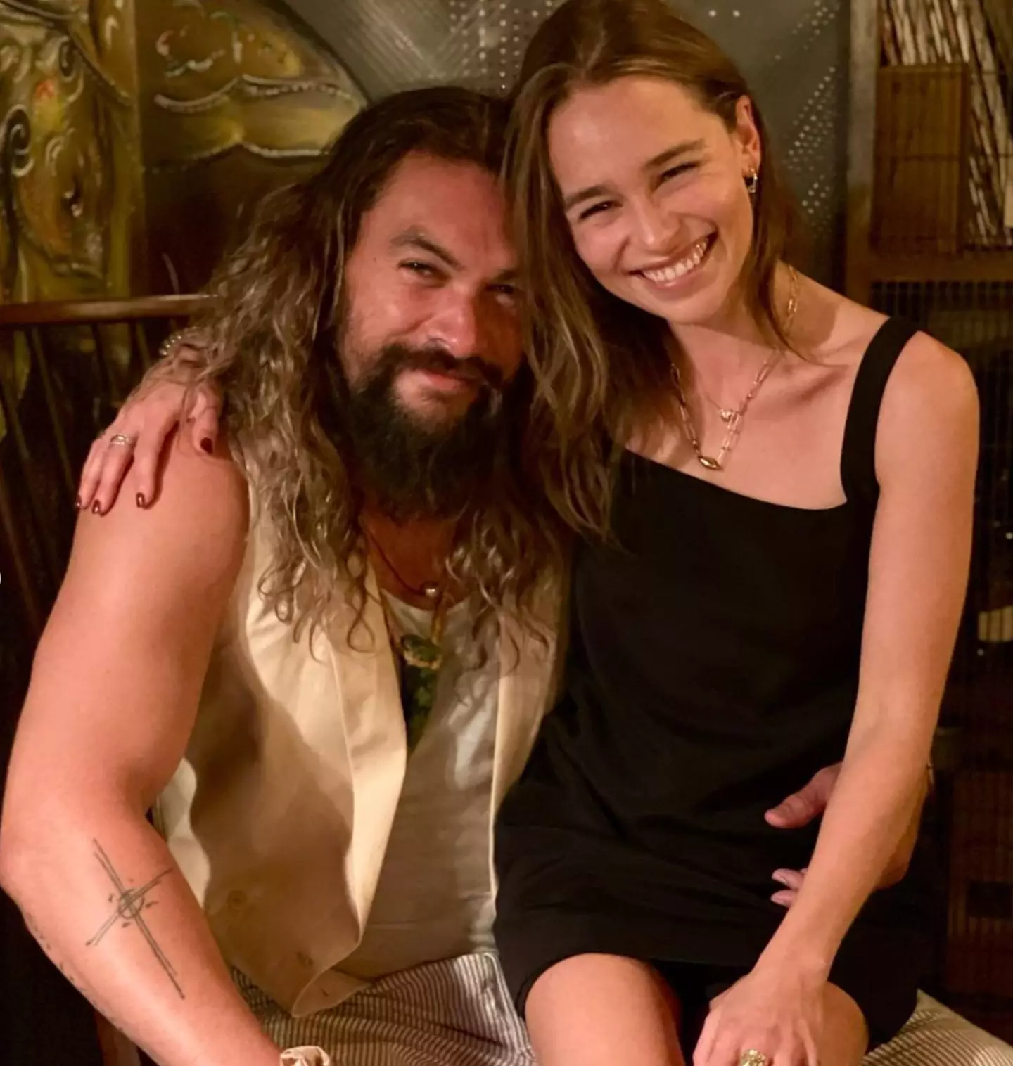 Fans are going back to this photo of Emilia Clarke with Jason Momoa. (