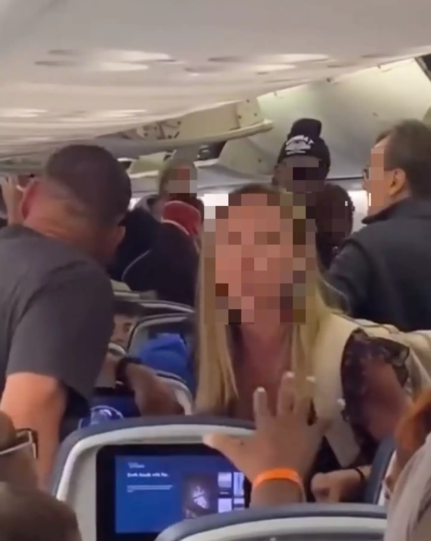 The woman accused the passenger behind her of repeatedly kicking her seat when she reclined it.