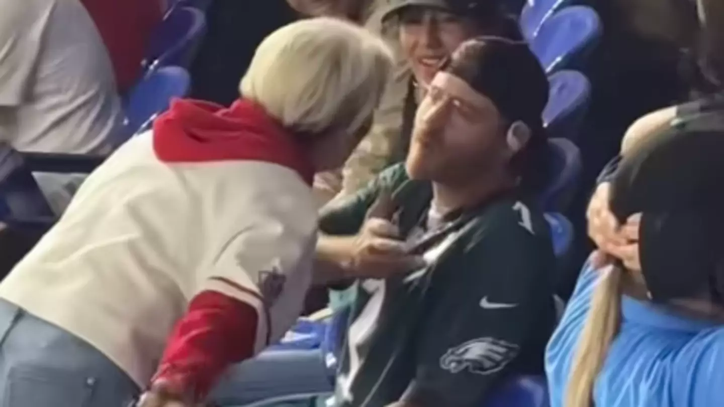 Woman who 'stole' ball from boy caught making rude gesture to fans after heated incident