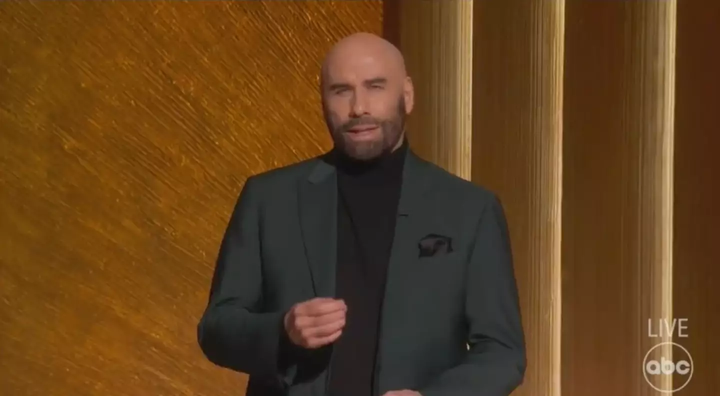 John Travolta held back tears while paying tribute to Olivia.