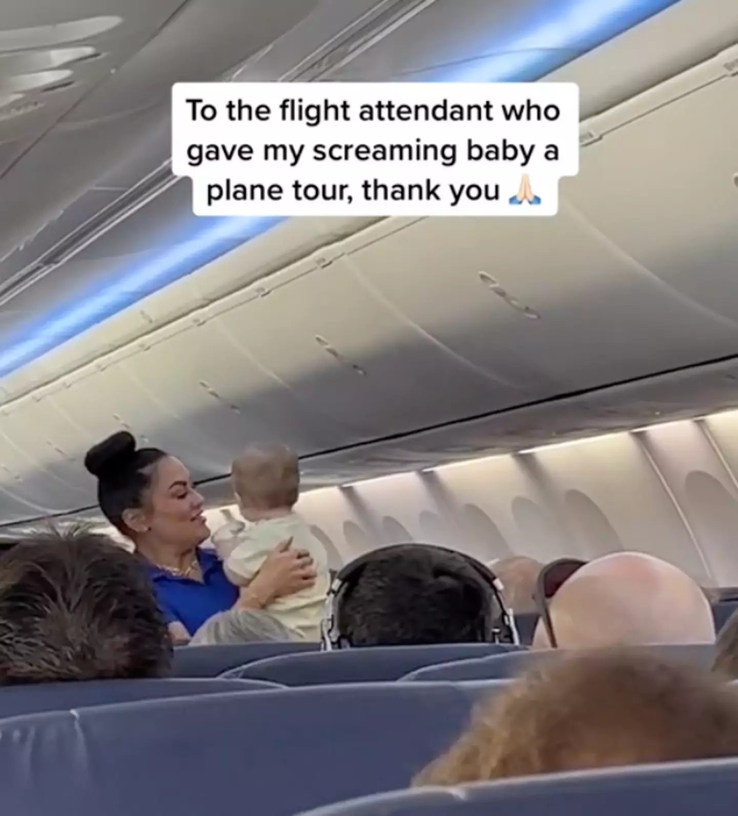 A flight attendant has been praised for helping a new mum with her baby.