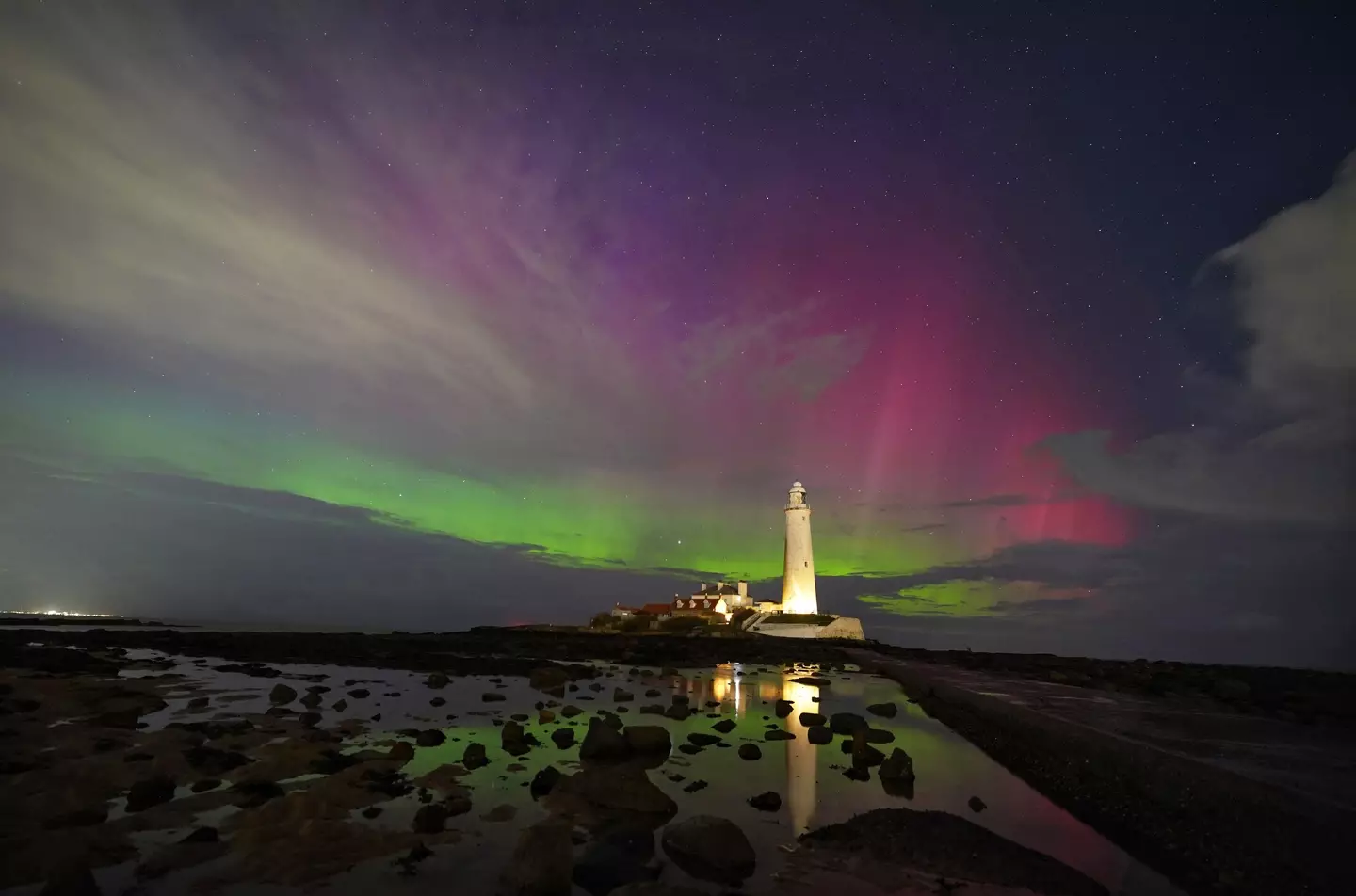 The Northern Lights pictured on the horizon at St Mary's Lighthouse in Whitley Bay on the North East coast.