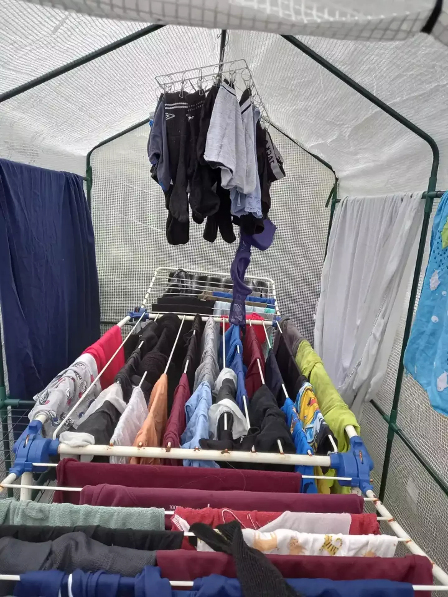 A mum has shared how she uses a plastic greenhouse to dry her family's washing.