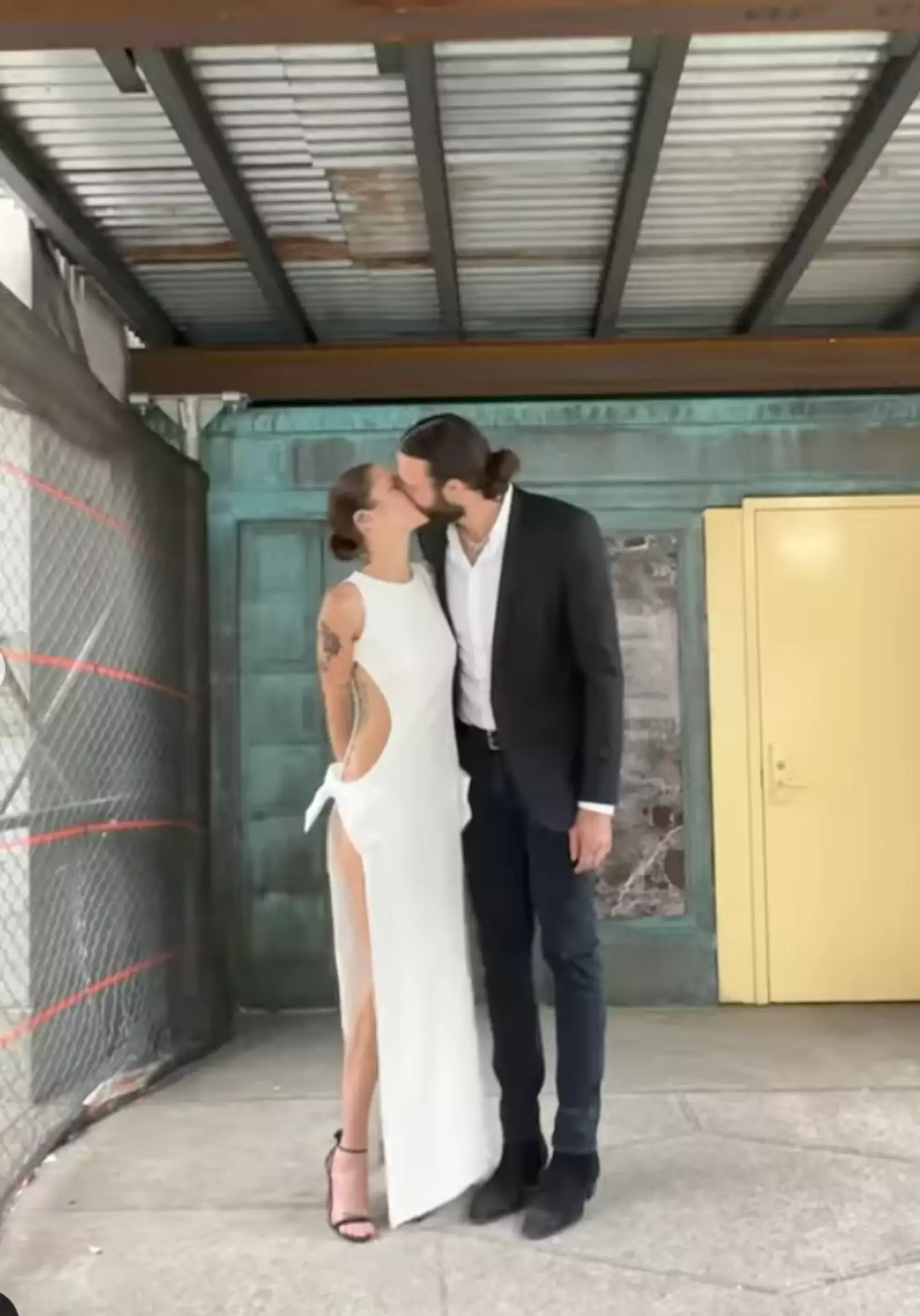 The newlyweds shared a happy kiss after the ceremony.