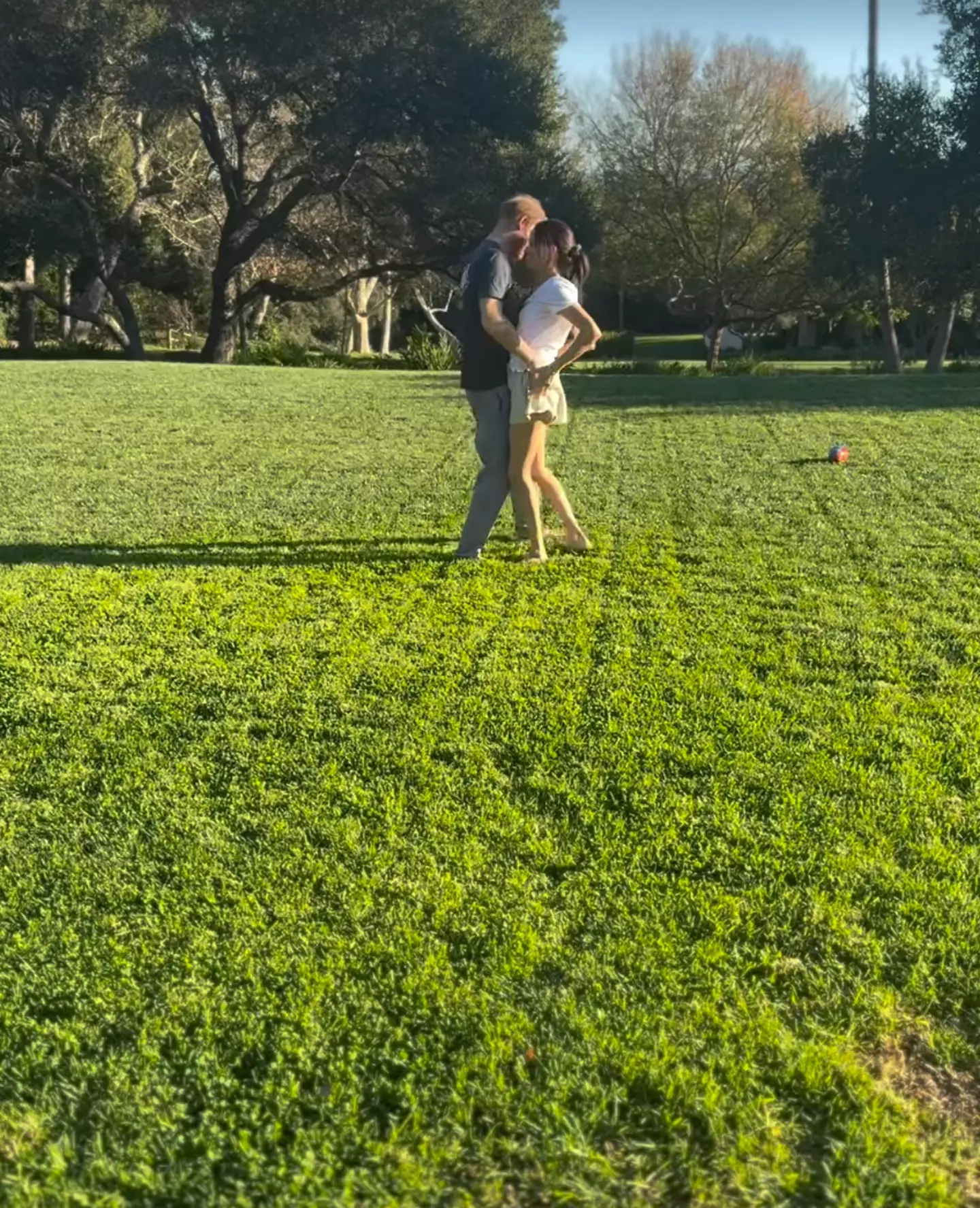 Harry can be seen grabbing his wife's behind (Instagram/@meghan)