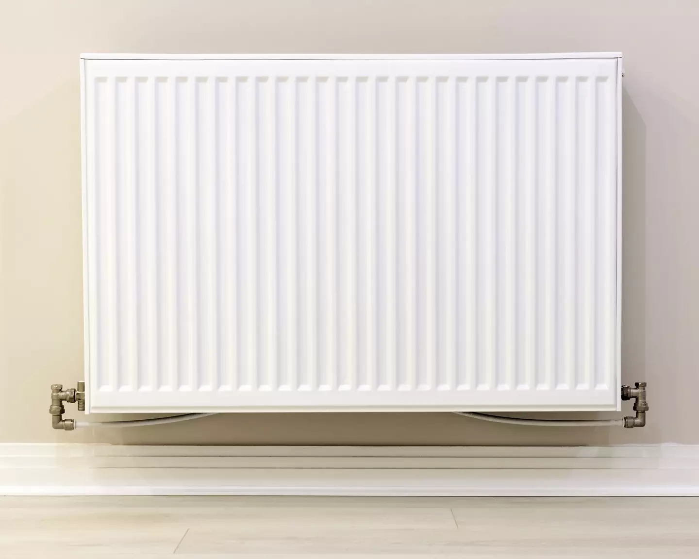 The woman put her clothes airer next to the radiator.