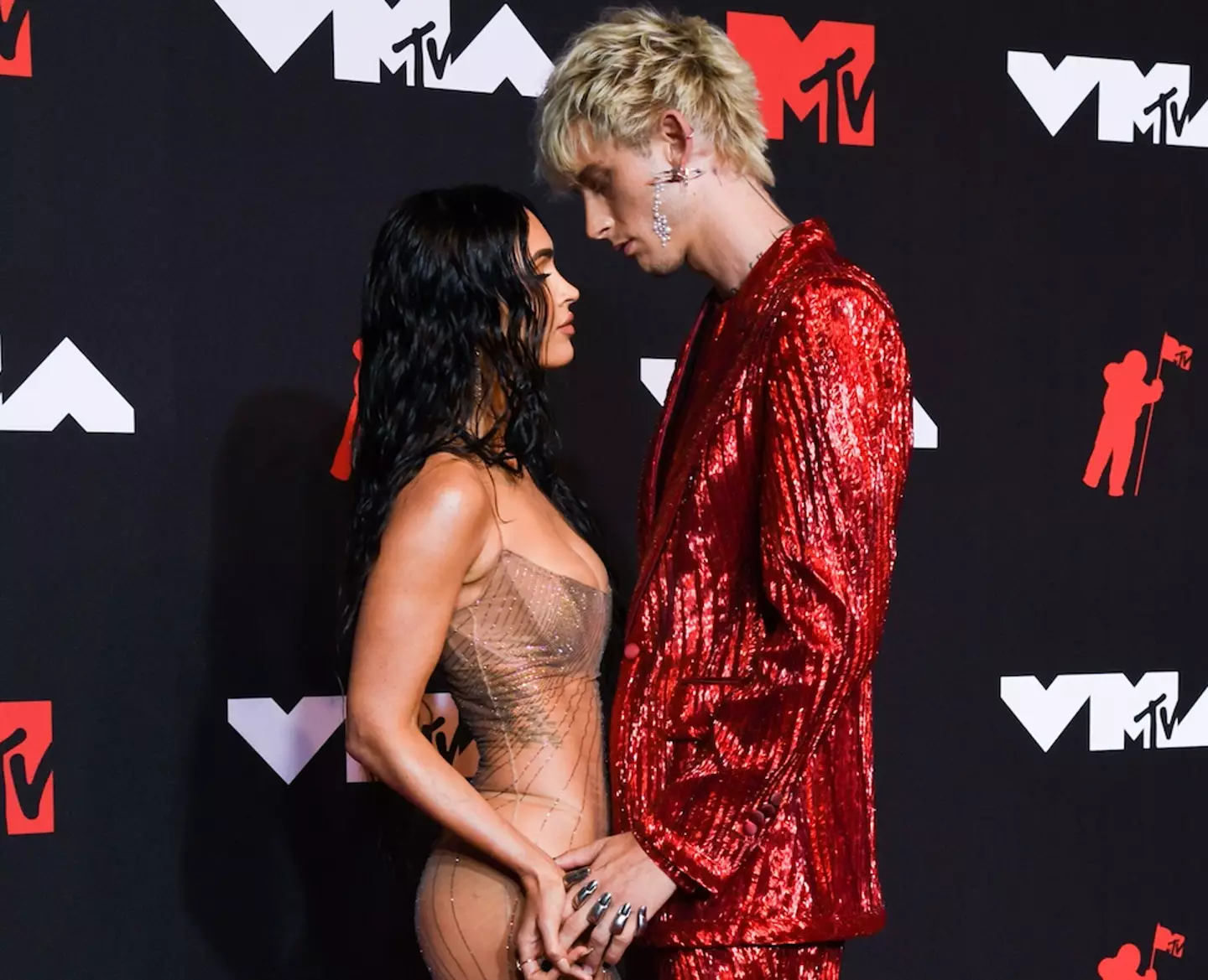 Megan and Machine Gun Kelly embrace each other at the MTV VMAs. (