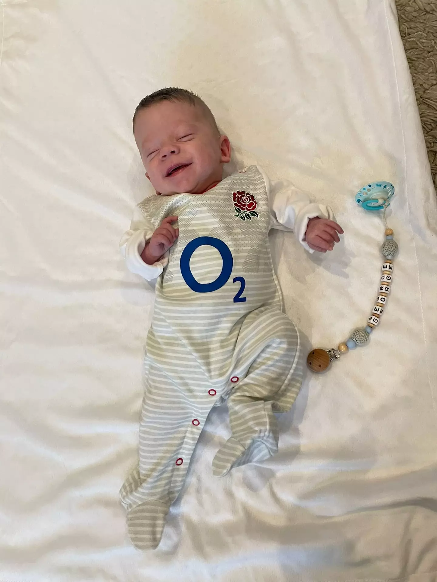 The gifted babygrow that once swamped the little boy now fits him perfectly.