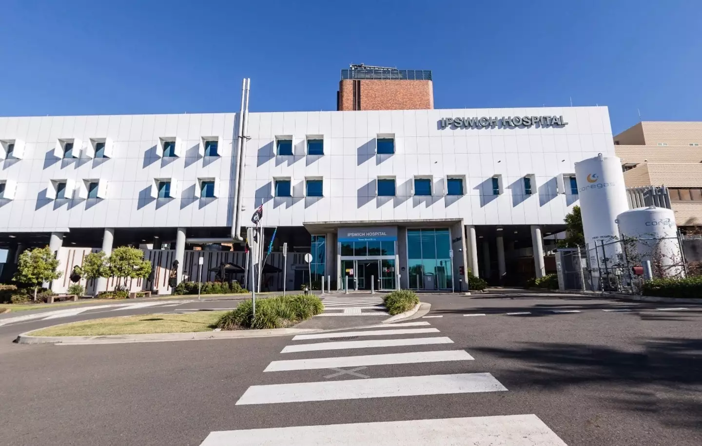 A mum claims she was forced to hold her dead baby in a biohazard bag in a hospital waiting room, which has left her traumatised.